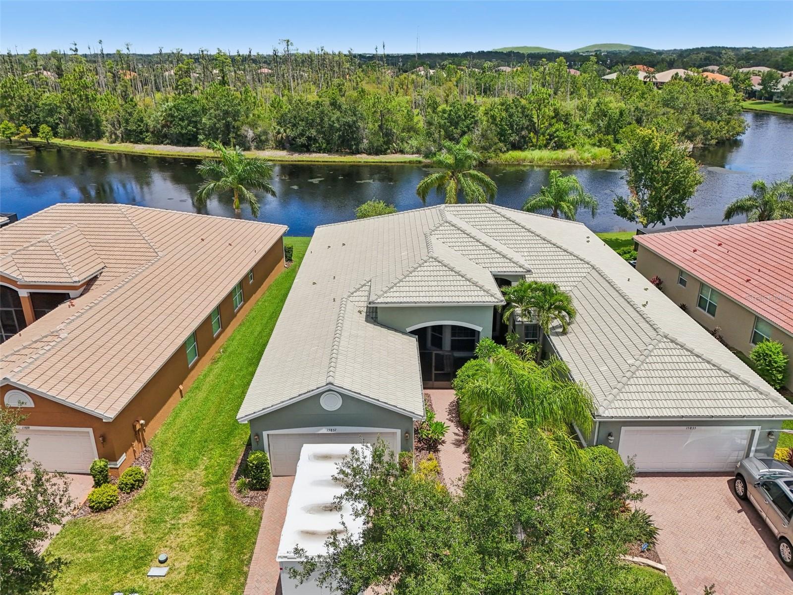 Discover this exquisite waterfront home nestled in the desirable Valencia Lakes community. This well-maintained 2-bedroom, 2-bathroom residence includes a dedicated office—ideal for remote work or a cozy lounging space. The property features a designer brick driveway, a spacious 2-car garage, and a beautifully landscaped walkway with lush, colorful flowers.
Step inside to an airy, open-concept living space with high ceilings and seamless flow between the kitchen, living room, and dining room. Expansive sliding glass doors open to a bright Florida room overlooking the water, perfect for relaxing and entertaining.
The kitchen is both functional and stylish, offering stainless steel appliances, abundant cabinetry, an eat-at bar, and a dinette area that’s perfect for casual meals.
The large primary suite includes water views, two walk-in closets, and a luxurious en suite bathroom complete with a double vanity and walk-in shower. The adjacent Florida room provides an additional serene space to unwind while taking in the waterfront vista.
Valencia Lakes is a premier 55+ active adult golf cart community, offering a vibrant lifestyle surrounded by resort-style amenities. The community features a stunning 40-acre waterfront outdoor recreation area with a heated resort pool, lap and resistance pools. Residents enjoy access to a 40,000 sq. ft. clubhouse, Har-Tru tennis courts, a state-of-the-art fitness center, half-court basketball, pickleball and bocce courts, a dog park, baseball park, and a community garden.
For outdoor enthusiasts, there’s over 100 acres of preserved natural areas, perfect for enjoying peaceful water views, birdwatching, and local wildlife. Additional conveniences include RV and boat storage and hundreds of clubs and activities to suit every interest.
Valencia Lakes is known for its warm, welcoming neighbors and strong sense of community — the perfect place to enjoy an active and fulfilling lifestyle.