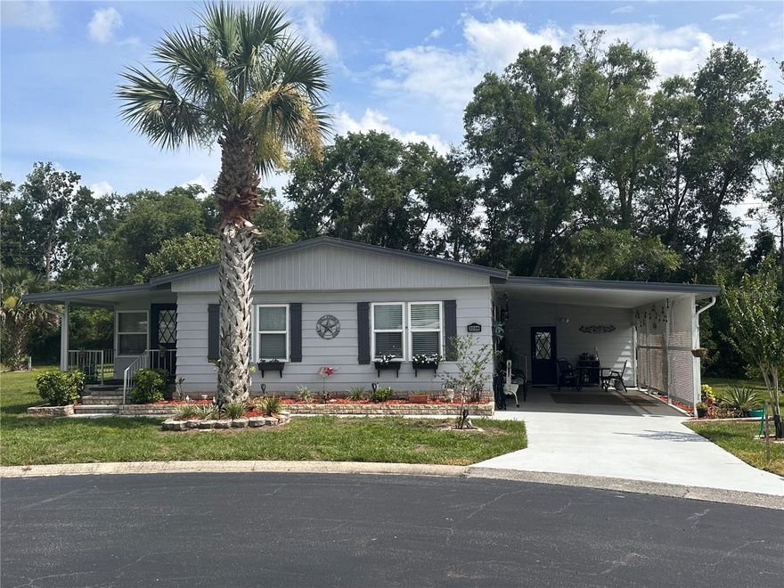 55+ gated community located in Zellwood, fl. just north of Orlando with easy access to freeways. This move in ready home has been updated  with, 3/4" plywood subfloors, water proof laminated flooring, QUARTZ counter tops on Kitchen, baths and foyer, new master bath cabinet, newer plumbing, double pane windows, 51/4" wood baseboards, textured wall recently painted.New Water Heater, Has one of the biggest sheds in Zellwood Station aprox. 20x17 with window ac and washing tub. Many amenities in this community, 18 hole golf course, fishing lakes pools galore, Full service restaurant and bar, daily, weekly and yearly major events, magic shows, entertainers, Christmas parades. This is heaven on earth. LAND OWNED AND PET area. those two are very important because by owning the land your HOA fees are less and been in a Pet area you can legally have a pet. Carport driveway has been professionally treated and has a 15 year warranty. Many fruit and just many trees from Lime, to Avocado, to plantain to sugar apple, Barbados berries, Florida peaches, many many more. Front door is 36" wide when most here are only 32" wide.