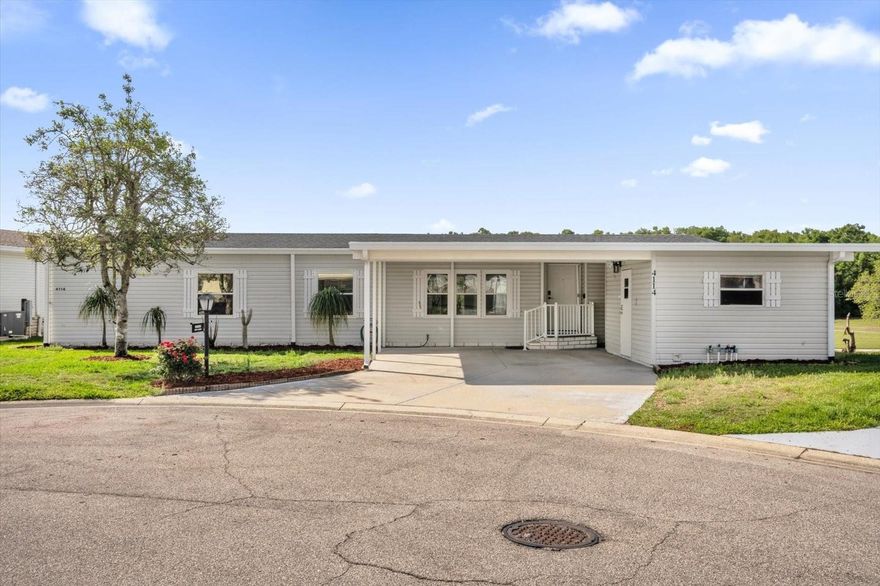 Drive into Peace and Tranquility and experience the pinnacle of the Zellwood Station lifestyle in this expansive, meticulously maintained 3/2 "Executive" home. Perfectly positioned on a quiet cul-de-sac. This residence offers breathtaking Unobstructed views of the golf course and lake directly across the street----providing a picturesque backdrop for your morning coffee without  the "on-the-green" foot traffic. Step inside to find a modern, open layout that feels more like a traditional site-built home. The heart of the home is the  massive kitchen renovated in 2022, boasting a 5.5 foot Granite Island, an additional Granite coffee bar and upgraded black appliances . The kitchen and the  Florida Room were designed specifically to frame the stunning water and golf views. All popcorn ceilings have been professionally scraped and painted, giving the entire home  a crisp, contemporary feel.  With nearly 2000 square feet of heated living space, you'll enjoy a formal dining room (18x17),  a dedicated dining room and an additional family room (14x13). The Primary Suite is a true retreat (16x13) featuring a large walk-in closet and double vanity. This home features A NEWER ROOF (2017) High-Efficiency 3.5 Ton A/C (2021), Screened Porch converted to Florida Room 2023 (17x11) with a new Split System. THE LOW PROFILE ENTRY WITH A WIDE LANDING AND HANDICAP-ACCESIBLE DOOR provides ease of entry rarely found in the community. ZELLWOOD IS A PREMIER 24/7 GUARD-GATED 55+ Community, featuring 18 hole golf course, on-site restaurant, pools and countless activities. Don't wait---homes with this combination of square footage and views are a rare find!!!!