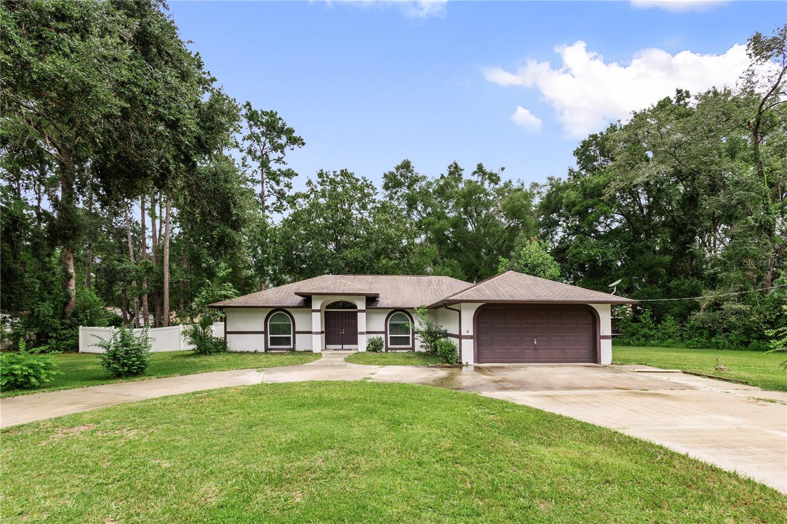 One or more photo(s) has been virtually staged. Located in the heart of Williston’s desirable Northwood Estates, this charming three-bedroom, two-bathroom home sits on an oversized wooded lot surrounded by trees and a fully fenced backyard, offering both privacy and serenity. The split floor plan features a spacious family room and a dedicated dining area, enhanced by elegant radius windows in the dining room and second bedroom that bring in natural light while maintaining privacy. Each bedroom includes a walk-in closet, and the main suite boasts a large walk-in glass shower and generous counter space. The separate kitchen is outfitted with brand-new countertops and new stainless steel appliances, including a dishwasher, oven, microwave, and refrigerator. Central air was updated just four years ago, and the laundry area is conveniently located in the hallway leading to the two-car garage. Outside, a large driveway includes a dedicated cut-out for RV parking—ideal for travelers or additional vehicle storage. With its thoughtful layout, modern updates, and peaceful surroundings, this home is ready to welcome you with comfort and charm.