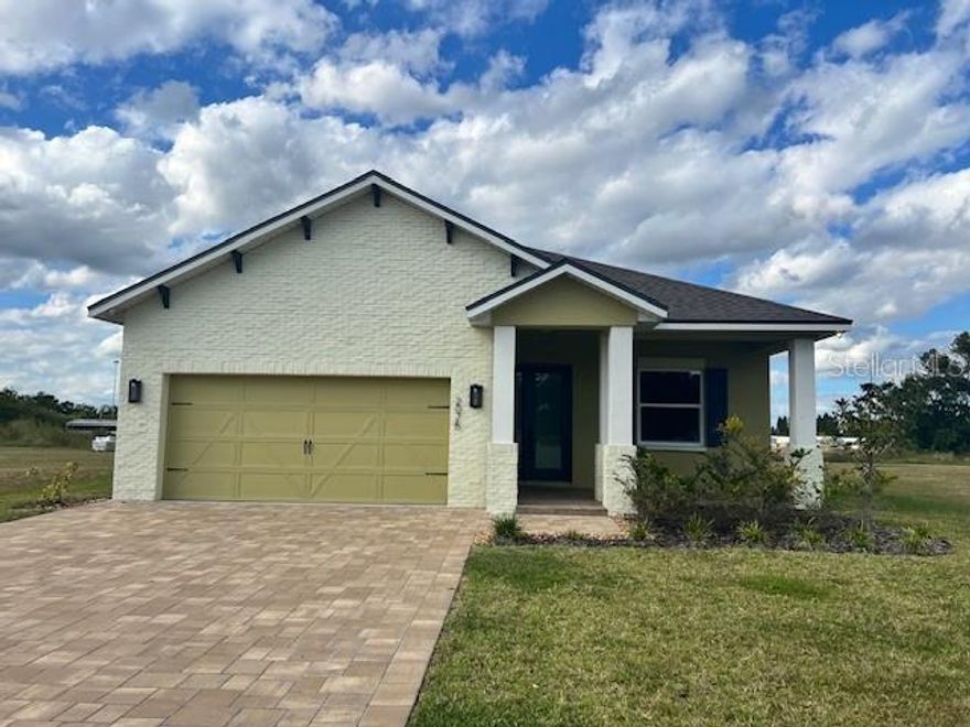 Only one year old, this 3/2 plus office home is in a small neighborhood of homes with a view of Lake Victoria. This home features pavers in front, 2 car garage, tile floors with carpet in bedrooms, screen lanai with an outdoor grill with a great view of the lake.  Tray ceilings, ceiling fans, master bath with dual sinks, inside laundry room with a sink and large open rooms are additional features.  The kitchen has solid surface counters and a good sized pantry and is an open kitchen with dining room and family room.