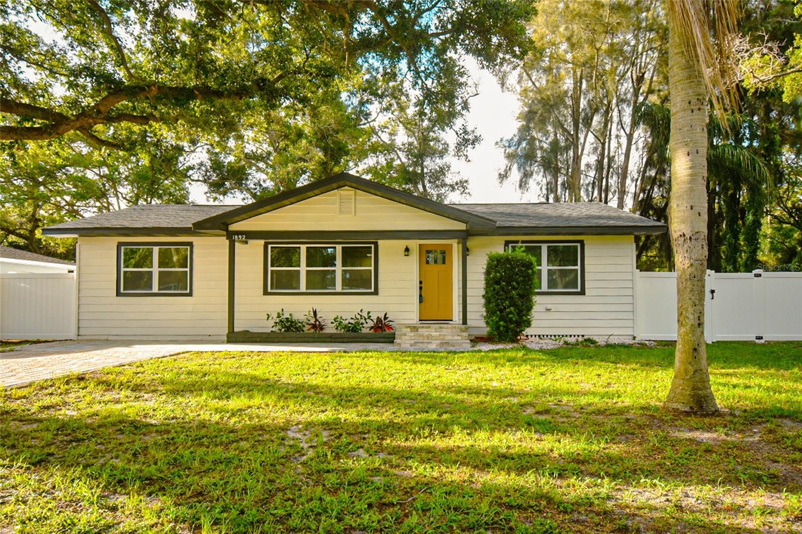 This one-of-a-kind property is back on the market. Located in the heart of Clearwater this impeccably remodeled 3 bed, 2 bath property features modern upgrades throughout the house creating the perfect blend of style and comfort. This property with a spacious layout, boasts a brand-new kitchen with modern shaker cabinets, stone counters, beautiful backsplash and new stainless-steel appliances including a wine refrigerator. The property showcases a stylish flooring throughout the house. All the bathrooms are upgraded with contemporary, tiles, vanities and fixtures. The House is completely weather proofed with new high impact hurricane windows and doors, new roof and new A/C and the owner just installed a new vinyl fence all around the property for more privacy. All work has been completed with permit from City of Clearwater as per Florida Building Code. The best feature of the property is the large family room filled with warmth and brightness. The fireplace makes this room the perfect space for family gathering. From the family room you will have access to a covered screened porch area with a beautiful and very relaxing backyard view. The property is located on a dead-end road far from the noises and traffic. This Clearwater gem is located minutes from the beautiful Clearwater Beach, TPA airport, SPC College, Clearwater and Countryside mall and many plazas with great dining and entertaining experiences. Don't miss out on this exciting opportunity!