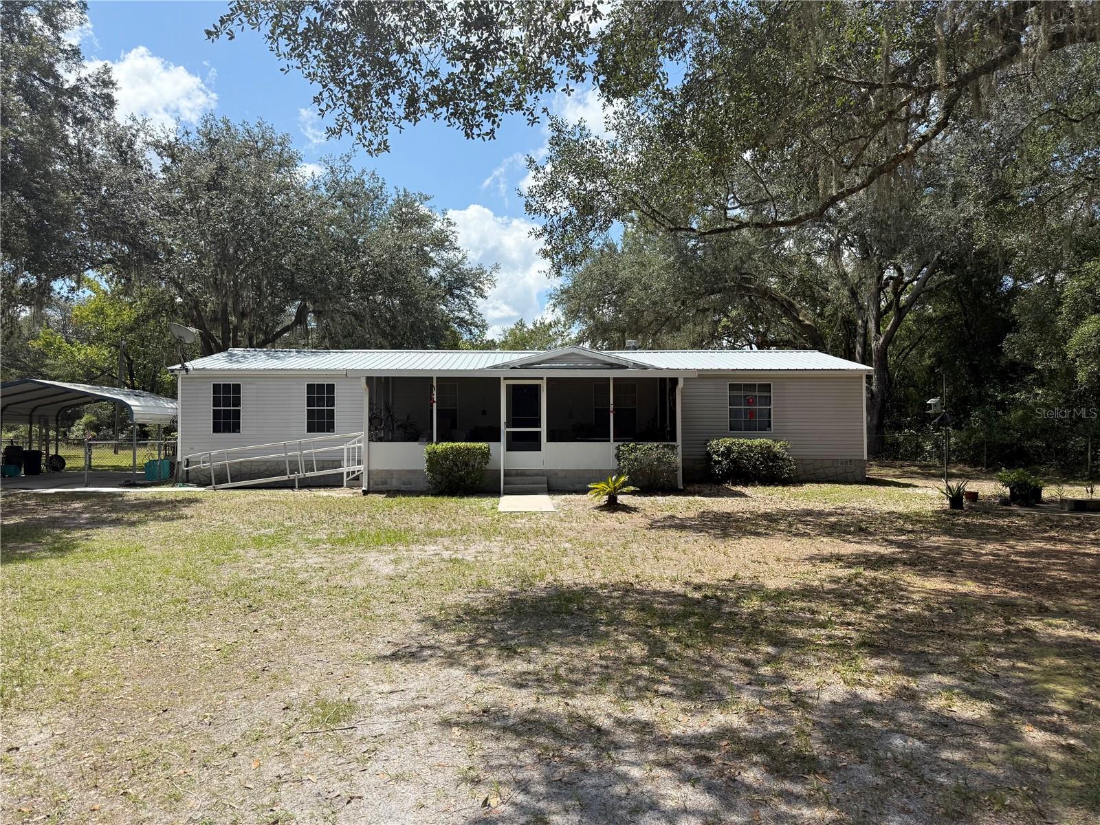 WELCOME TO THE PEACEFUL AND PRIVATE COUNTRY LIVING WITH THIS THREE BEDROOM AND TWO BATH MOBILE HOME POSITIONED ON THE BACK PART OF OVER 2 ACRES OF WELL-CARED FOR LAND. THIS 1992 FLEETWOOD DOUBLE WIDE MOBILE HOME HAS BEEN WELL CARED FOR BY ONE OWNER AND LIFETIME MEMORIES. THE HOME FEATURES A NEWER METAL ROOF (2017), NEW WELL (2025), AND NEW CENTRAL HEAT AND AIR UNIT (2025). ENJOY YOUR MORNING COFFEE ON THE SCREENED IN FRONT PORCH WHILE WATCHING THE HUMMINGBIRDS AND SQUIRRELS SQUIRY AROUND IN THE QUIET COUNTRY MORNINGS. THE PROPERTY ALSO HAS ONE COVERED CARPORT NEXT TO THE HOME AND A LARGE UTILITY SHED FOR THE WORKSHOP OF YOUR DREAMS! THE PROPERTY IS LINED WITH BEAUTIFUL MATURE TREES FOR PRIVACY AND A CIRCULAR DRIVEWAY LOOP UP TO THE HOME. THIS BEAUTIFUL PROPERTY IS AWAITING FOR YOU!