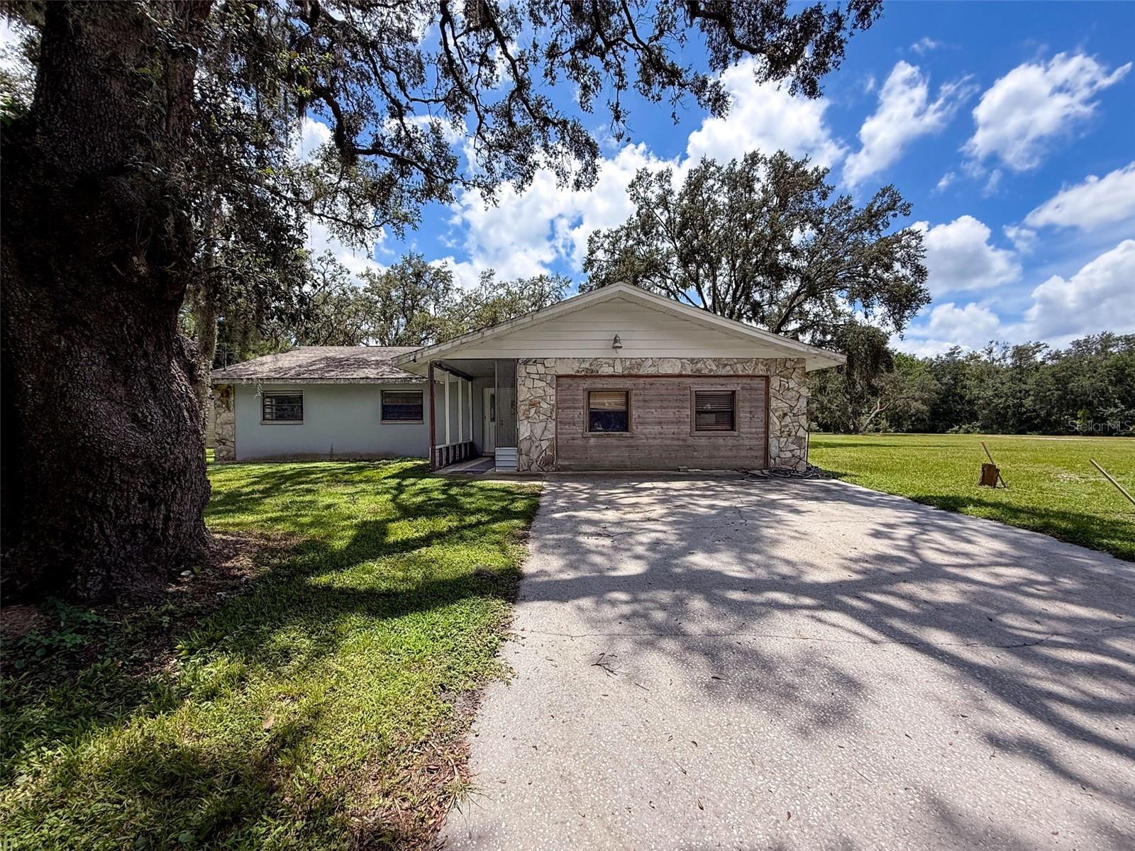 Calling all family compound seekers, home builders and developers. Are you looking for 2.5 acres in Odessa, right off State road 54? Welcome to Keystone Park. (Or should I say Grey Hawk) Located next to Lake Polo, the beautiful gated community of Grey Hawk was built around this beautiful piece of land in the early 2000s. Imagine having the security of a guard attended gated entrance and not have to pay the $200 a month HOA that all your neighbors do. That's right, with purchasing this home, you would have the option to join or NOT join the HOA because technically you are not part of Grey Hawk. That means you aren't paying the high taxes either. We have a 5 bedroom, 2 bath home and the potential to build a family compound or for a builder to come in and build 6-8 very large homes on their own 10,000+ sq foot lots. The land is all clear and ready to build. Now let's talk about the location. Conveniently located one mile from the Suncoast Parkway with very easy access to just about anywhere north or south. Heading East you're right in the middle of Lutz, Land O Lakes and Wesley Chapel and West toward Trinity and New Port Richey. Surrounded by some of the best shopping and dining in all of Tampa Bay; This is an amazing opportunity for the right person as an investment or family looking to keep their loved ones close. Call or text with any questions.