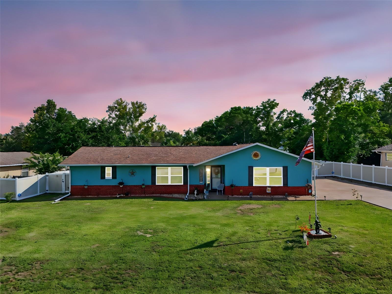 Welcome to this delightful single-family home in Ocala, boasting an eye-catching turquoise exterior and a well-maintained lawn. The property features a privacy-fenced backyard, providing a safe and secluded space for outdoor activities, complete with a shed for extra storage and a fire pit for evening gatherings.
Step inside to an inviting and functional interior. The living room is bright and comfortable, with large windows flooding the space with natural light. The open-concept design seamlessly connects the living area and dining areas to the central kitchen, which features a large island with granite countertops, white cabinetry, and stainless steel appliances. The wood-look flooring extends throughout the main living spaces, creating a cohesive and modern feel.
Relax or entertain in the enclosed Florida room, which is currently set up as a game room with a pool table. This versatile space offers a perfect transition to the backyard. The bedrooms are cozy, with carpeting for comfort and newly updated bathrooms. This home is a perfect blend of style and practicality, offering a great living experience.