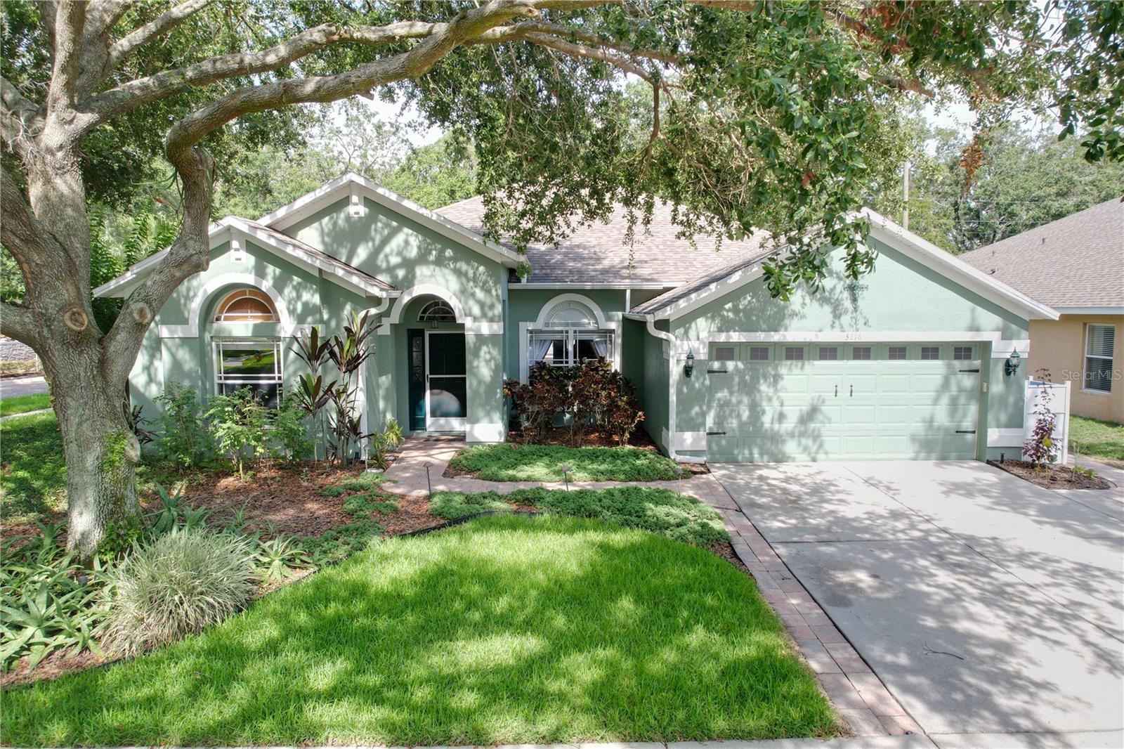 Welcome to your own perfect retreat! This meticulously maintained 4-bedroom, 2-bath home sits on an oversized corner lot in a quiet 40-home enclave with a peaceful community pond. Designed for both everyday comfort and exceptional entertaining, this home offers the best of Florida living—inside and out. Entertain effortlessly indoors with an open, three-way split floor plan, engineered wood and tile floors in most of the home. A chef’s dream, this welcoming kitchen is equipped with 42" cabinets, pull-out shelving, Corian countertops, gas stove, decorative backsplash, crown molding and a plant shelf with LED lighting. Whether hosting a dinner party or casual get-together, the flow between indoor and outdoor spaces is seamless—especially with the second full bath offering direct lanai access for guests. Inside, you’ll find multiple living spaces to fit every lifestyle. The large family room, with a vaulted ceiling, is the heart of the home, ideal for relaxing or hosting game nights, while the separate living room or den provides flexibility—perfect as a home office, formal sitting room, or media space. Retreat to the incredibly spacious primary suite, large enough for a king-sized bed, seating area, and more. It features a double tray ceiling, huge walk-in closet with extra ventilated shelving, and a beautifully remodeled ensuite. Step into luxury with elegant travertine flooring accented by custom details. The spa-like bathroom showcases double Corian vanities, a freestanding clawfoot tub, and a stunning walk-in shower complete with body sprays and a rainfall showerhead. The three additional bedrooms are generously sized, with walk-in closets, except the fourth bedroom which has double doors – ideal for a home office. Additional highlights include a stacked 3-car garage with tons of storage, newer roof (2019), AC (2020), and water heater (2017), 2” faux blinds and ceiling fans throughout, and many smart home features. The half wall in the dining area is set up to accommodate a large aquarium for added visual interest. The outdoor space is a true showstopper, centered around a gorgeous, deep blue saltwater pool with a shimmering PebbleTec finish that glistens in the sunlight. The rich color adds a resort-like feel and makes every dip feel luxurious. The pool (added in 2018) also features solar heating, a custom quick-drain system, and smart remote access for effortless control. Whether you're enjoying a quiet morning swim or hosting a sunset pool party, this stunning feature sets the stage for relaxation and entertainment. The expansive pavered lanai and deck features a 6-person spa, fire pit area, coax cable for TV, ample space for outdoor dining, and hosting unforgettable gatherings. Professionally landscaped and fully irrigated, the fenced yard completes this backyard paradise. The worry of annual maintenance has also been addressed with a recent service by HomeSmiles, taking care of the AC service, dryer vent cleaning, draining the water heater, window washing, and so much more! Located in a top-rated school district and just minutes from parks, the YMCA, shopping, dining, and with quick access to I-75 and the Crosstown Expressway to Downtown Tampa—this home checks every box. If you love to entertain and relax in style, this home is the one you’ve been waiting for!