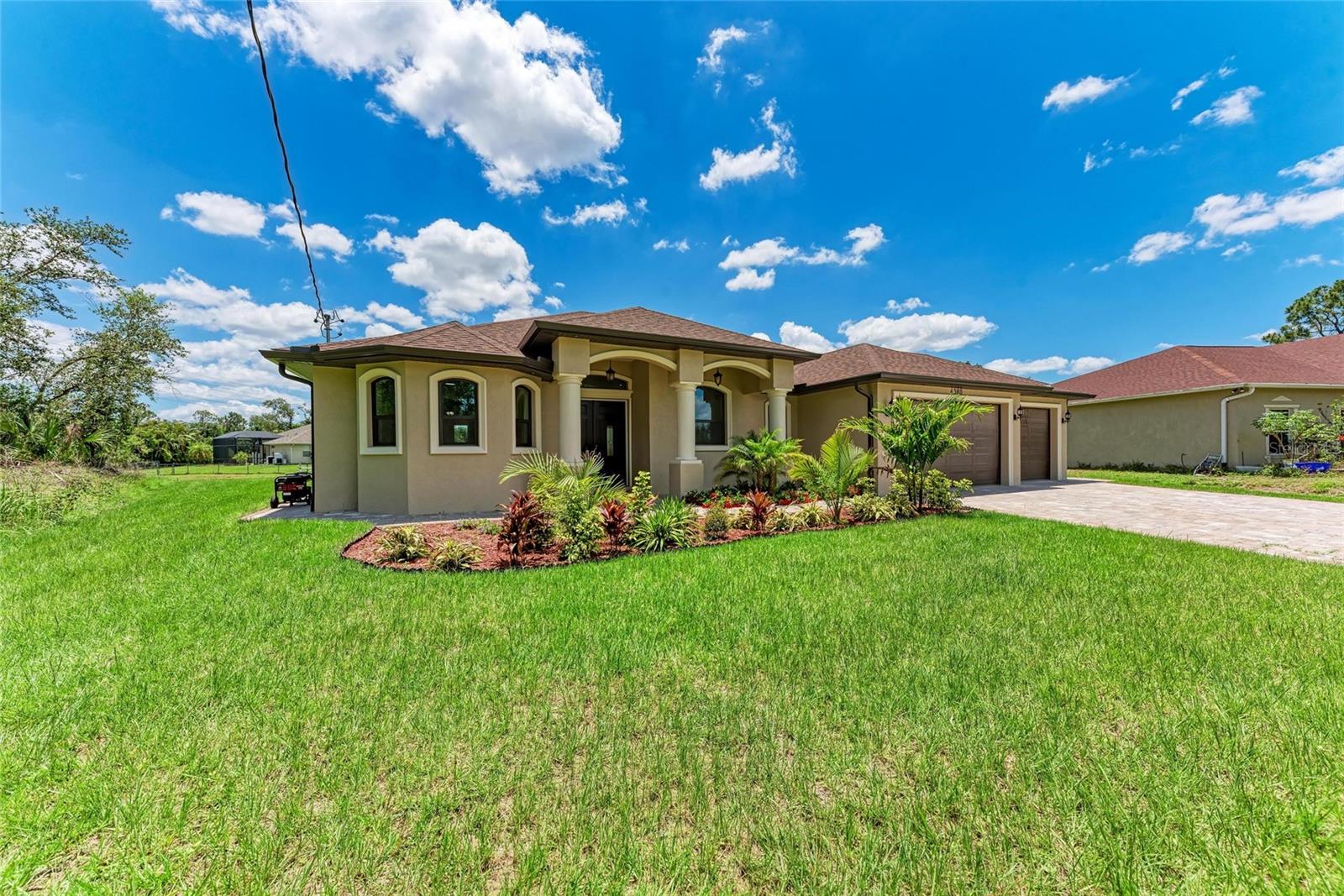 Home is just days away from getting Certificate of Occupancy. SPECTACULAR custom built home on oversized lot located a few minutes away from entrance to interstate. No details were overlooked in this NEW construction home. The long, extra wide full 3 car brick paver driveway sets the tone of what you will experience upon arrival. The lush landscaping catches your attention as you approach the stunning impact front doors with leaded glass inserts. Open the front doors and you'll start to spot the details are EVERYWHERE. You'll immediately notice the custom paint. Move on to the abundance of LED lighting, including color changing in the coffered ceilings, as well as the upgraded lighting fixtures and fans. Kitchen features an amazing amount of cabinets with display insert doors (and interior lighting in cabinets too), counterspace, and the super sized island. The nook has more cabinets, a wet bar and a wine fridge. Living room has a mood setting electric fireplace. Primary bedroom has French doors which open up to the rear lanai. The en-suite primary bathroom has dual vanities, a jetted bath tub and the shower has both hand-held as well as rainfall water delivery. The 3 car garage features interior concrete board walls with stucco & epoxy flooring and has garage door openers already in place. Impact doors and windows throughout. The rear lanai also has an outdoor kitchen area with sink.