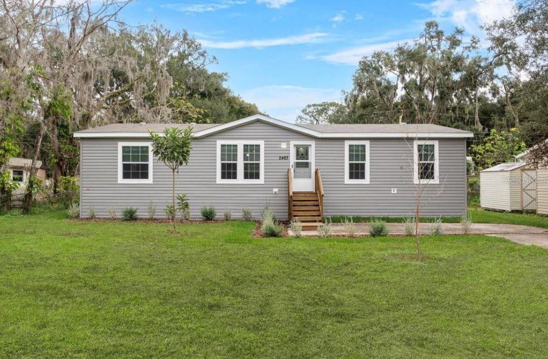 USDA ELIGIBLE -2463 Wildwood Drive is located in a close-knit community with a small-town feel of Mims, FL. This brand-new Peyton-Plus model manufactured home sits on .18 acres, with no HOA, and offers just under 1,400 sq. ft. of living space that includes 3 spacious bedrooms, 2 full bathrooms, and an additional den room, perfect for the home office. As you step inside, you'll be greeted by an open floor plan with vinyl flooring throughout, and vaulted ceilings that enhance the open and airy feel of the home, offering a comfortable and contemporary living space. The spacious living room seamlessly flows into the kitchen and dinette area, perfect for entertaining guests. The kitchen is a chef's delight, featuring a central island with breakfast travertine countertops, shaker-style cabinets, walk-in food pantry, and brand-new appliances. The master bedroom is a serene retreat, complete with a walk-in closet and a luxurious en-suite master bath with a dual sink vanity, linen cabinet, shower stall, and island tub, perfect for soaking the day away! This home offers a den area that is perfect for a home office and two additional bedrooms providing plenty of space for family members or guests. For added convenience, this home offers a dedicated laundry/utility room. Mims boasts a close-knit community with a small-town feel, while still providing convenient access to modern amenities like local shops, and restaurants for dining, with the nearby city of Titusville offering additional shopping, dining, and entertainment options. For those who love the beach, the pristine shores of the Space Coast are just a short drive away, perfect for a day of sun and surf. Nature enthusiasts will appreciate the close proximity to the Indian River, Merritt Island National Wildlife Refuge, and Enchanted Forest Sanctuary, which offers easy access to stunning waterfront views, a variety of outdoor recreational activities, including boating, fishing, kayaking, hiking trails that meander through lush landscapes. Additionally, Mims is conveniently located near major highways, making it easy to commute to the greater Orlando area for work or leisure. Don't miss out on this incredible opportunity to own a brand-new manufactured home in a prime location with no HOA! Schedule your private showing today to make this house your home, and experience the best of Florida living!