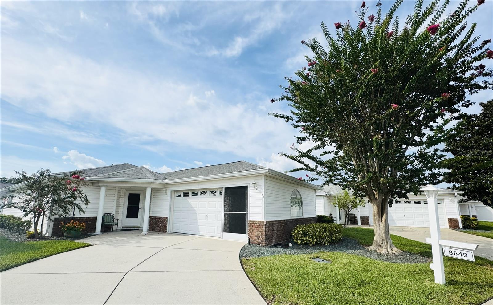 This Cypress II Villa offers 2 bedrooms, 2 bathrooms, 1,356 sq ft of living space, and a two-car garage on a desirable lot within Del Webb’s Spruce Creek Golf & Country Club. Features include, tile backsplash in the kitchen, large walk-in closet, an enclosed lanai, and a laundry area in garage. The HOA fee covers lawn care, weeding, trimming, and irrigation. Enjoy access to over 70 clubs, three pools and spas (including indoor and outdoor options), fitness center, tennis, pickleball, golf, dining at Liberty Grille, and more. Located near The Villages with convenient shopping, restaurants, and medical facilities. Move-in ready and perfect as a primary residence, seasonal home, or investment opportunity—schedule your showing today!