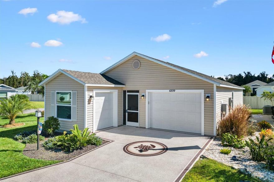 Built 2023 • Better Than New • Corner Lot with Dual Garages and Waterfall Feature Welcome to this Better-Than-New 2023 Moonstone Patio Villa in the Village of Lake Denham, The Villages, Florida. This 2-Bedroom, 2-Bathroom villa delivers modern design, quality upgrades, and low-maintenance living in one of The Villages’ most vibrant and newest neighborhoods. From the moment you arrive, curb appeal shines with a decorative driveway and corner lot that adds distinction and privacy. The property features two separate garages: an extended 1-car garage (12x16) plus a golf cart garage (10x9) offering ample storage and easy access for vehicles and golf carts alike. Step inside to a bright, open-concept floor plan highlighted by Luxury Vinyl Plank (LVP) flooring throughout the main living areas. The spacious kitchen showcases Shaker-style cabinetry, a working island with breakfast bar, stainless steel appliances, and a gas range that overlooks the living and dining spaces, creating a seamless flow ideal for entertaining. The Primary Suite provides a peaceful retreat with a walk-in closet, adjustable bed, and private ensuite bath featuring a dual-sink vanity, walk-in shower with sliding glass doors, and a separate toilet closet. The guest bedroom includes a built-in closet and easy access to the guest bath with a tub/shower combination. Additional interior highlights include a large storage closet, inside laundry area, and tasteful furnishings throughout, making this home turnkey (except smoker and golf cart) and gently lived in. Enjoy the Florida lifestyle year-round in the screened lanai, perfect for morning coffee or evening relaxation. Step outside to beautifully enhanced landscaping that includes a tranquil waterfall feature, extending the outdoor living area and adding a touch of serenity to your private corner setting. Practical upgrades and systems are already in place, with energy-efficient construction, natural gas utilities, and a modern design built to today’s standards. For added convenience, a 2023 4-seater golf cart is available for purchase outside of contract—an ideal way to explore The Villages in style. This prime Lake Denham location provides close proximity to numerous recreation and golf destinations: Mickylee Pitch & Putt (0.5 mi), Franklin Recreation Center (0.5 mi), Homestead Recreation Center (1.6 mi), Southern Oaks Championship Golf Course (2.5 mi), Laurel Oak Executive Golf Course (2.5 mi), Jubilee Putting Course (2.8 mi), and Eastport Town Square (4.9 mi). Combining newer construction, thoughtful upgrades, and a rare dual-garage configuration, this Moonstone Villa offers turnkey comfort, stylish finishes, and easy access to all that The Villages lifestyle provides.