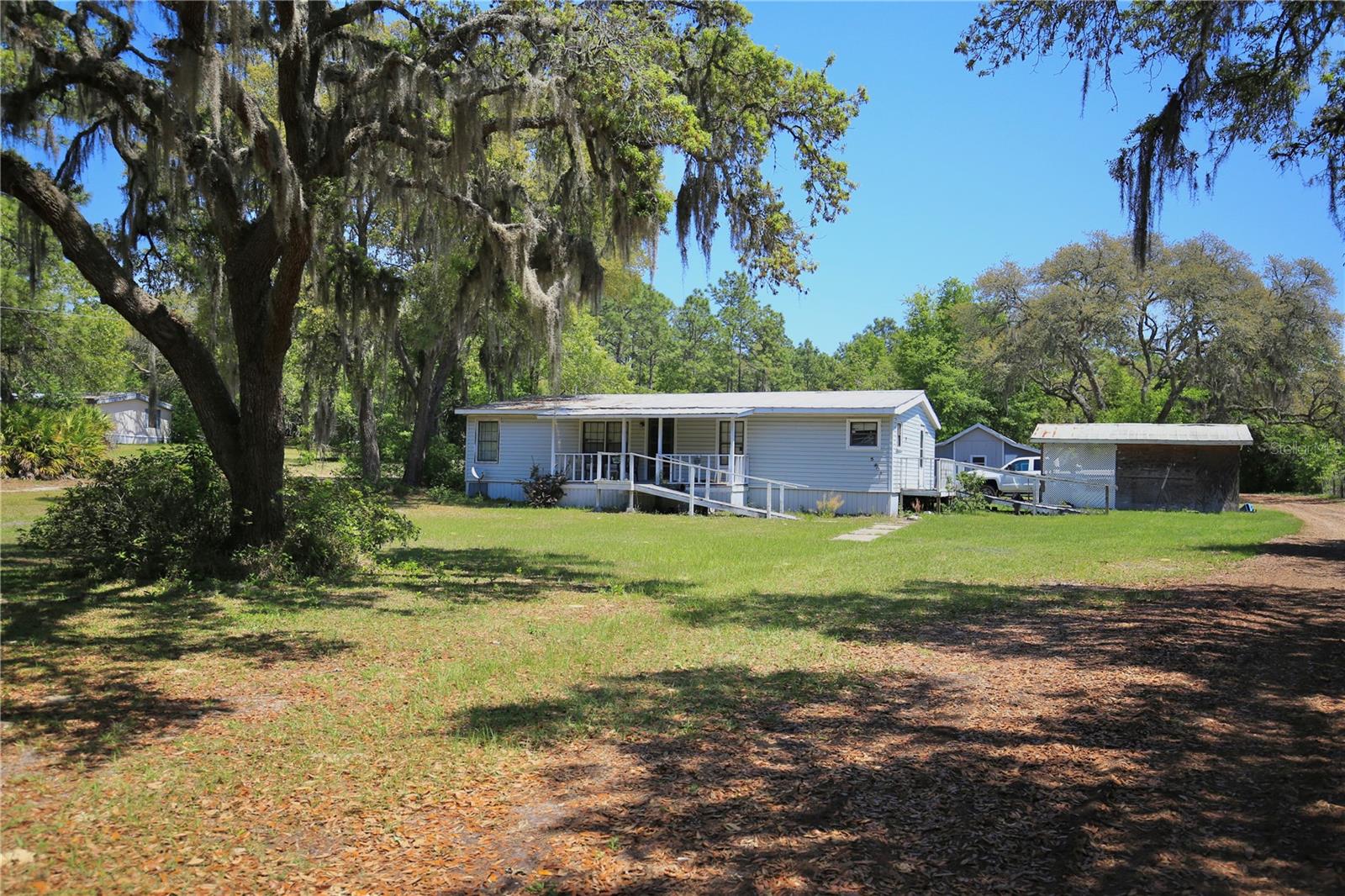 This spacious mobile home offers tons of potential and room to make it your own. Nestled on over an acre of land, the 3 bedroom, 2 bath layout is ideal for comfortable living, with plenty of outdoor space for gardening, pets, or play. While it does need some TLC, the seller is including some materials to help you jumpstart your renovation projects.The property features a lovely shed for additional storage or workshop use, and there’s plenty of room for all your tools, toys, or hobbies. The home includes handicap-accessible features for added convenience and peace of mind. Whether you're looking for a project or a peaceful place to settle in, this one has great bones and even better potential. Don’t miss the opportunity to turn this into your dream country retreat! Seller plans to haul off all junk upon receiving acceptable offer.
