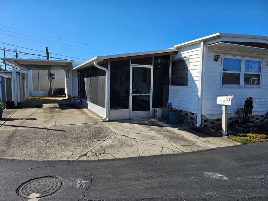 This 2 bed 1.5 bath mobile home is located in Twin Gables a Resident Owned 55+ Community.  The Home is NOT in a flood zone. The HOA Fee is $150 a month.  The home had a new roof over installed in September of 2018 The electrical box and wiring was updated in 2018 as well.  The home has vinyl siding and a large screen room  with a washer, dryer and 3 storage sheds.  The driveway with carport can easily fit 3 cars.  The vinyl flooring has been replaced throughout the home.