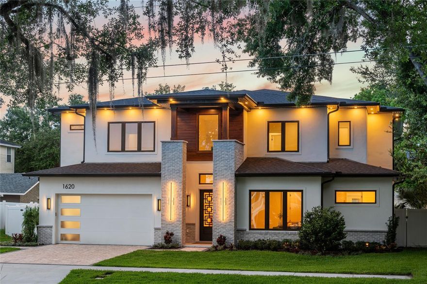 Welcome to this stunning newly constructed home, perfectly situated on a spacious ¼-acre lot in the highly coveted Delaney Park neighborhood. Offering over 4,000 square feet of thoughtfully designed living space, this 5-bedroom, 5.5-bathroom residence showcases luxury, sophistication, and impeccable craftsmanship throughout. From the moment you step inside, you’ll be captivated by the wide plank white oak hardwood flooring, soaring ceilings, custom solid core doors, and high-end designer finishes. At the front of the home, a light-filled office with a closet provides the flexibility of a 5th bedroom. The expansive primary suite is a serene retreat featuring an electric fireplace, French doors for direct access to the backyard, a large walk-in closet, and a spa-like en suite bathroom complete with dual sinks, soaking tub, and an oversized walk-in shower with built-in massage system. The heart of the home is the open-concept living area, where the spacious family room, dining space, and gourmet kitchen seamlessly blend for effortless entertaining. The kitchen is a true showstopper—equipped with a premium Café appliance suite, quartz waterfall island, walk-in pantry with custom cabinetry and shelving, designer pendant lighting, gas range with pot filler, and a stunning fluted white oak range hood. A stylish wet bar with wine fridge and electric fireplace flanked by custom built-ins completes the family room. Expansive sliding glass doors lead to a beautifully landscaped, fenced backyard oasis. Enjoy outdoor living year-round with a covered lanai featuring tongue & groove ceilings, a full outdoor kitchen with sink, gas grill, beverage fridge and bar seating, plus a luxurious heated PebbleTec saltwater pool and spa with sunshelf, water feature, and two dramatic gas fireballs. Additional features include a full pool bath, white vinyl privacy fence, irrigation system, landscape lighting, and rain gutters. The first floor also includes a half bath and a well-appointed laundry room with custom cabinetry and utility sink. Upstairs, you’ll find three generously sized bedrooms, each with its own en suite bathroom and walk-in closet, a large loft space with wet bar, and a covered balcony overlooking the backyard. Smart & Energy-Efficient Features: Whole-property WiFi with four access points (including full outdoor coverage), Two high-efficiency HVAC systems, Three Rinnai tankless gas water heaters, Ring doorbell + four CCTV security cameras, Comprehensive ADT security system with door sensors, variable speed high efficiency pool pump. All of this is ideally located walking distance to Lake Davis, Lake Cherokee, Delaney Park’s tennis courts, baseball fields and playground, and A-rated Blankner K-8 and Boone High School. Enjoy the convenience of being near SODO, Thornton Park, Orlando Health, and the Dr. Phillips Performing Arts Center. Don’t miss your chance to own this one-of-a-kind, new construction masterpiece in one of downtown Orlando’s most sought-after neighborhoods!