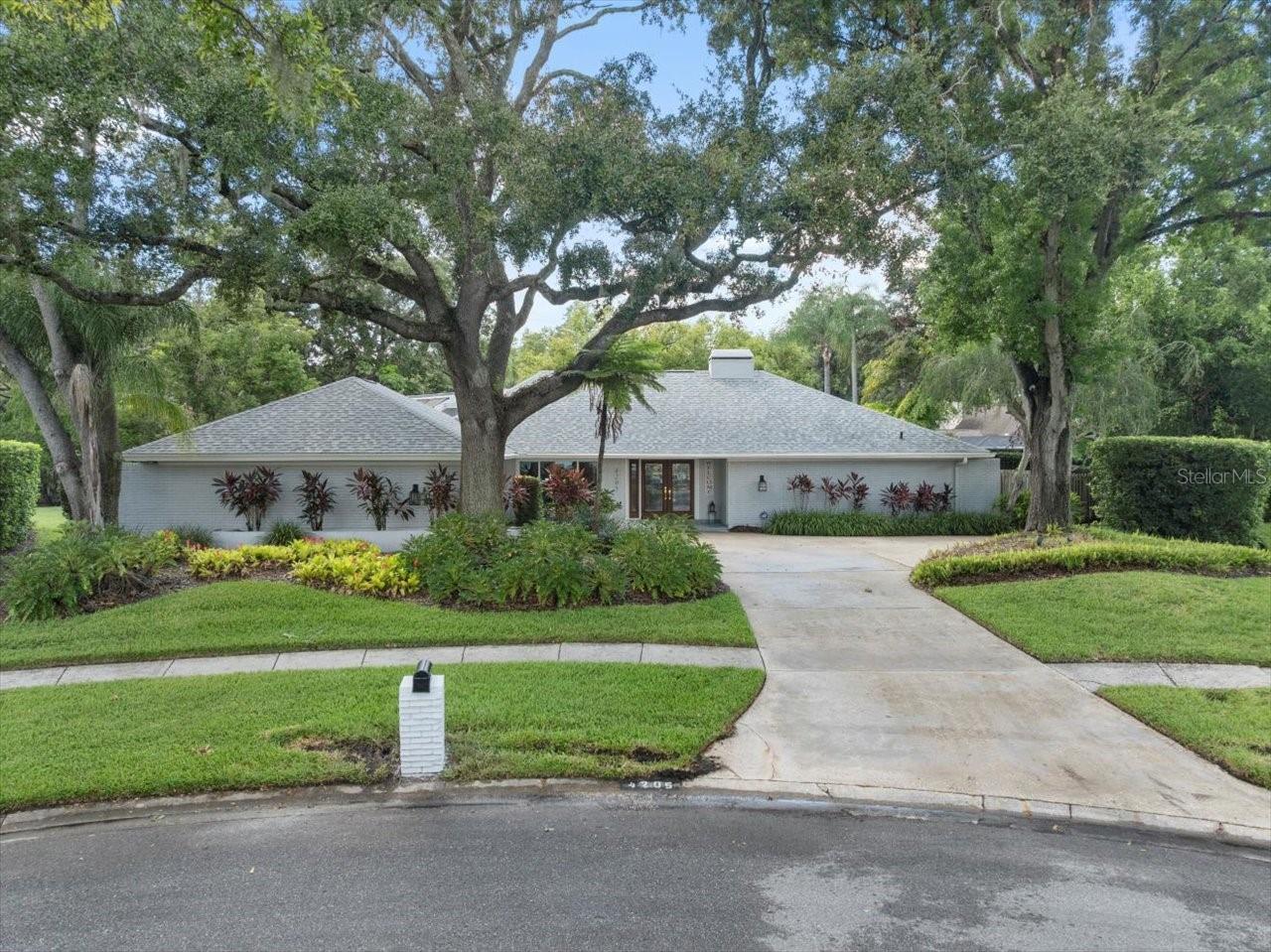 Tucked away on a quiet cul-de-sac in Carrollwood Village Phase 1, this beautifully updated 4-bedroom, 3-bathroom pool home offers a rare combination of elegance, privacy, and everyday comfort. Surrounded by mature landscaping and nestled in one of Tampa’s most coveted neighborhoods, this residence exudes timeless sophistication from the moment you arrive. Inside, a thoughtfully designed split-bedroom floor plan ensures privacy and flexibility, making it ideal for both family living and entertaining. At the heart of the home, the open-concept kitchen flows seamlessly into a spacious living area, where expansive views of the sparkling pool and outdoor oasis invite you to relax or host in style. From the family room, a serene courtyard with a custom firepit adds another layer of charm and intimacy, perfect for cool evenings under the stars.
The formal living room is anchored by a striking wood-burning fireplace and features updated sliding doors that open directly to the lanai and pool area. A separate formal dining room provides an elegant space for hosting gatherings or special occasions, while the oversized laundry room offers ample cabinetry and storage solutions to keep everything organized.
The luxurious primary suite is a serene escape with a spa-inspired en-suite bath, dual vanities, walk-in shower, soaking tub, and modern finishes. Three additional guest bedrooms are generously sized and tucked away on the opposite wing for added privacy.
Recent upgrades include a roof in 2019, 2 AC units in 2019, commercial water heater in 2021, Hurricane Rated Windows and doors, pool refinished 2020, Master Bath remodel 2022 and wood floors refinished in 2019!
Ideally located just moments from Carrollwood Village’s parks, tennis courts, walking trails, and vibrant community amenities, this exceptional home delivers luxury living in a picturesque, highly sought-after setting.