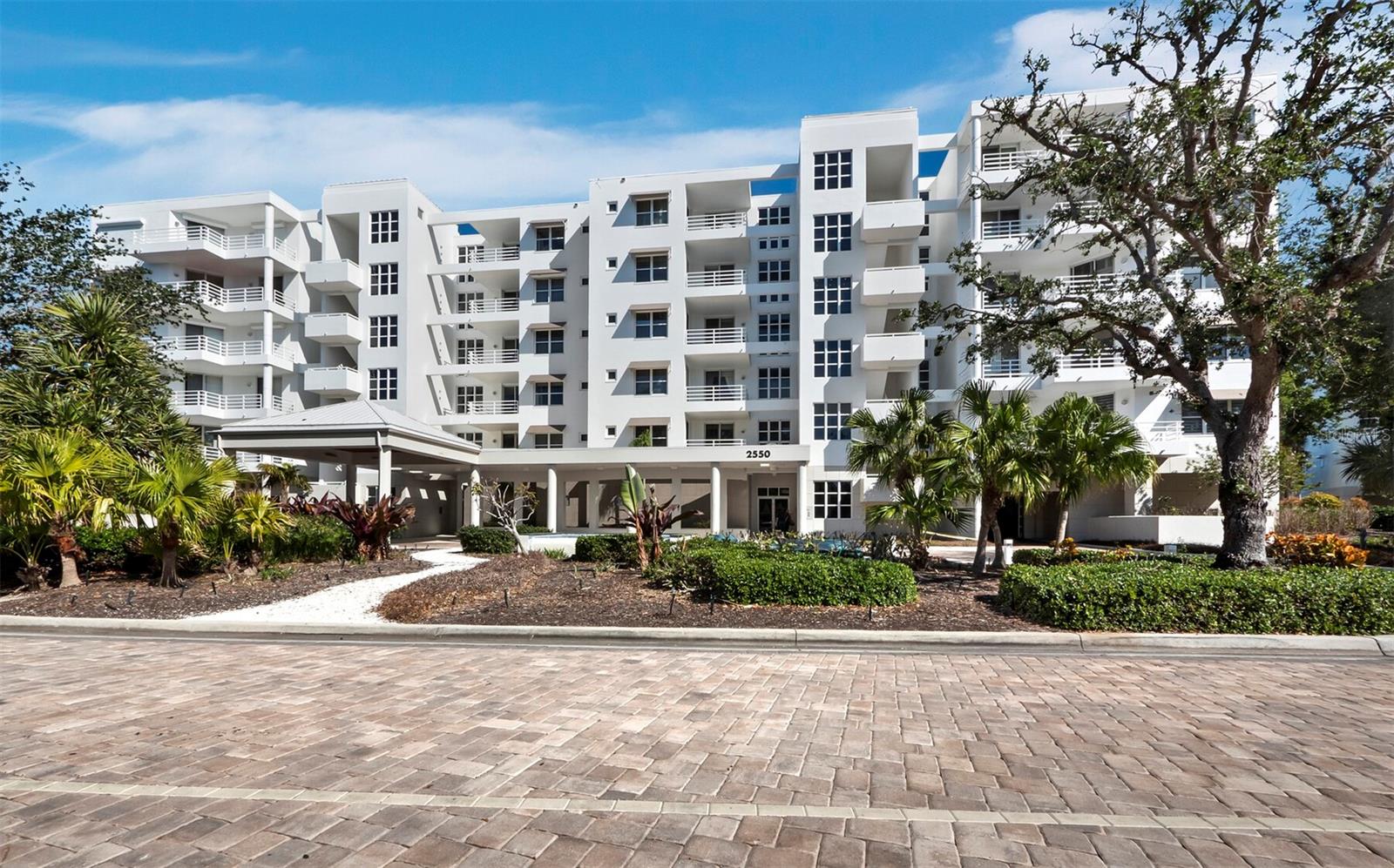 Located within the gated Bay Isles community, Marina Bay offers the best of Longboat Key living. This exceptional 3BR/3BA residence spans 2,830 sq. ft. and features an open floor plan with wood tile floors, recessed lighting, and tray ceilings. The spacious living area flows seamlessly to a screened terrace, where you can enjoy views of manicured grounds, the bay, and the city skyline. The kitchen is both stylish and functional, featuring a large center island with seating, all-white cabinetry, stone countertops, a matching backsplash, and premium stainless-steel appliances. The primary suite offers direct terrace access and a spa-like bath with a soaking tub, dual vanities, a glass-enclosed shower, and elegant tilework. Two additional bedrooms provide flexibility for guests or a home office. A laundry room with built-in desk space completes the interior. Marina Bay is pet-friendly and offers onsite management, a fitness center, a library, multiple tennis courts, and a heated pool. As a Bay Isles resident, you'll enjoy gated entry and exclusive access to the Bay Isles Beach Club, a private, deeded beach with white sands, Gulf waters, a pavilion, picnic areas, grills, and restrooms. Boat slips are available for purchase or lease at The Longboat Key Club Moorings, a premier deep-water marina with concierge services and top-tier amenities for vessels up to 150 feet.
