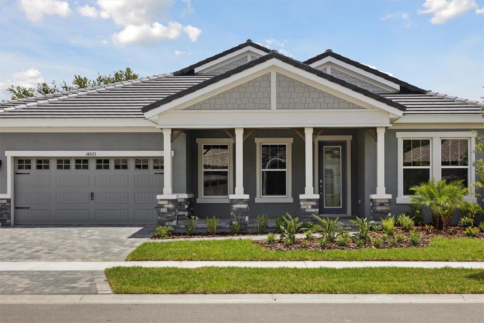 Key Largo I -
Presenting the Key Largo I, a remarkable home available for immediate occupancy. This residence showcases a refined aesthetic, featuring Maddox Painted Harbor cabinetry, pristine Frost Whie MSI Quartz countertops, and rich Home Nutmeg LVP flooring. The Key Largo I embodies a desirable one-story Florida open-style plan, meticulously designed to provide optimal comfort and functionality where it matters most. This remarkable residence, encompassing over 3,163 square feet, offers a thoughtfully designed layout featuring four bedrooms, three bathrooms, and a spacious three-car garage. Upon entering, you'll be captivated by the grandeur of 12-foot ceilings that extend through the foyer, formal dining room, grand room, and kitchen, creating an exceptionally open and inviting ambiance. At the core of this home lies an expansive, open-concept floor plan, centered around a chef-inspired island kitchen that flows effortlessly into the grand room, an ideal setting for both everyday moments and vibrant entertaining. The Owner's Sanctuary provides a private haven, accessed through elegant double doors. This luxurious space boasts dual walk-in closets, a dedicated dressing area, and a spa-like private bath, offering unparalleled comfort. Generously proportioned secondary bedrooms, a versatile bonus room, and an oversized laundry and hobby room further enhance the home's appeal. Additionally, a substantial covered lanai, seamlessly connected to the grand room, provides the perfect backdrop for embracing the Florida lifestyle.
