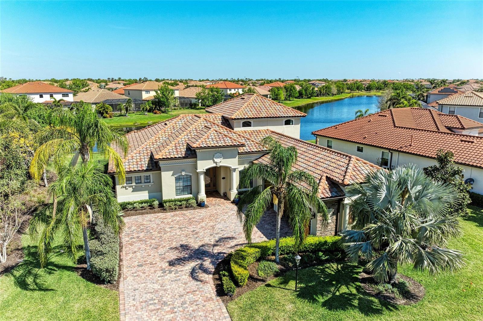 *** PRICE IMPROVEMENT ***. Discover a stunning home in Bridgewater, a fantastic gated community in Lakewood Ranch. This premium corner lot property offers beautiful water views, lush tropical landscaping, and maintenance-free living. The exterior boasts stunning architectural details with decorative stonework, a tile roof, and brick pavers. The fenced yard includes a screened-in lanai, and there's a three-car garage to store all your toys.
Step inside to 3,178 sq. ft. of elegant living space, featuring an open floor plan with tile throughout the main living areas and carpet in the upstairs area. High ceilings, upscale finishes, and fresh paint create a modern, comfortable atmosphere. The spacious great room flows seamlessly into the gourmet kitchen, complete with granite countertops, premium appliances, and an oversized island perfect for entertaining. The primary suite comes with a spa-like ensuite bath, and a generous walk-in closet.
The private lanai is perfect for relaxation or entertaining, with a heated spa and pool that shows off the stunning pond views. The pool can also be converted to a saltwater system for added convenience. Upstairs, a large bonus room with a kitchenette and full bathroom provides endless possibilities—ideal for a guest suite, media room, or private office.
Bridgewater residents enjoy access to a park, playground, and gazebo area overlooking a serene lake. Just outside the neighborhood, you’ll find three large lakes, a public playground, and scenic walking trails. Lakewood Ranch is known for its A+ rated schools and is just a short drive from Sarasota, Anna Maria Island, and I-75, offering easy access to Tampa, fine dining, world-class shopping, and the Gulf’s famous beaches.
Located minutes from top-rated schools, including Lakewood Ranch Preparatory Academy ( a public Tuition- free Charter school) , shopping, dining, and world-class amenities, this home offers the perfect combination of luxury, convenience, and community living. Don’t miss the opportunity to own this exquisite home and start living in paradise!