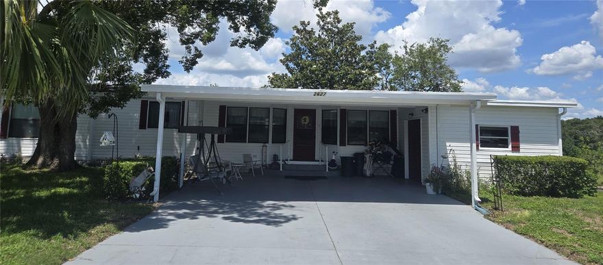 REDUCED MOTIVATED SELLER will entertain all reasonable offers. Updated pictures. 3-Bedroom 2 bath home with versatile extra bonus room for den, office, craft room. Located at the end of a cul-de-sac FLAT 2 CAR carport. PET FRIENDLY. NEW A/C 2025, EXTERIOR PAINTED 2024, SHINGLE ROOF 2018 and newer electrical box. Views of greenspace and woods from the screened porch. Zellwood Station is a Resident Owned 55+ Golfing Community located between Apopka and Mt Dora.  Come and see what we have to offer!