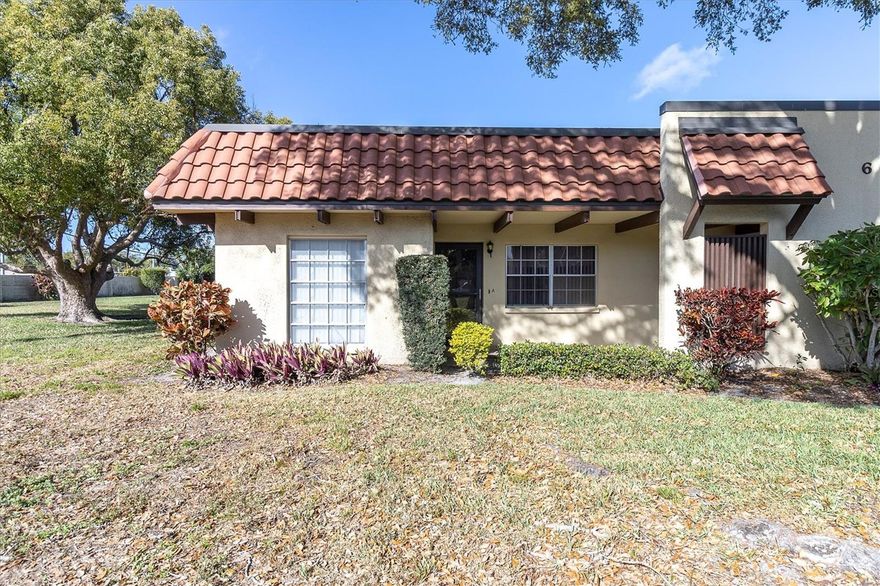 This nicely updated, villa-style condo in the vibrant 55+ Pinehurst Village community of Dunedin delivers easy living and modern updates. This unit is ADA accessible with a wheelchair ramp leading into the condo and grab bars installed in the bathrooms.  Inside, you’ll find a split layout with 2 bedrooms / 2 full baths and as an end unit, with a closed in Florida room, offering plenty of Florida sunshine, perfect for morning coffee or an evening unwind with the sunset. The interior is move-in ready and updated with 2024 luxury vinyl plank flooring. There have been no pets or smoking within the unit. Both bathrooms were upgraded in 2025. The roof was resurfaced in 2024, and the air conditioner was replaced in 2019 with the ductwork. The unit is adjacent to the laundry room and has covered assigned parking and guest spaces in front.Pinehurst Village offers a clubhouse, pool (heated during the winter months), shuffleboard, and a picnic area with grill, while the Dunedin Community Center and Fine Arts Center nearby offer endless activities. Conveniently situated minutes from Downtown Dunedin, the Pinellas Trail, Honeymoon Island, golf courses, parks, and the best dining and entertainment the area has to offer. Whether you’re a winter-time or a full-time resident, this villa is all about making life simpler and more convenient. Schedule your private showing now, this listing won’t last long.