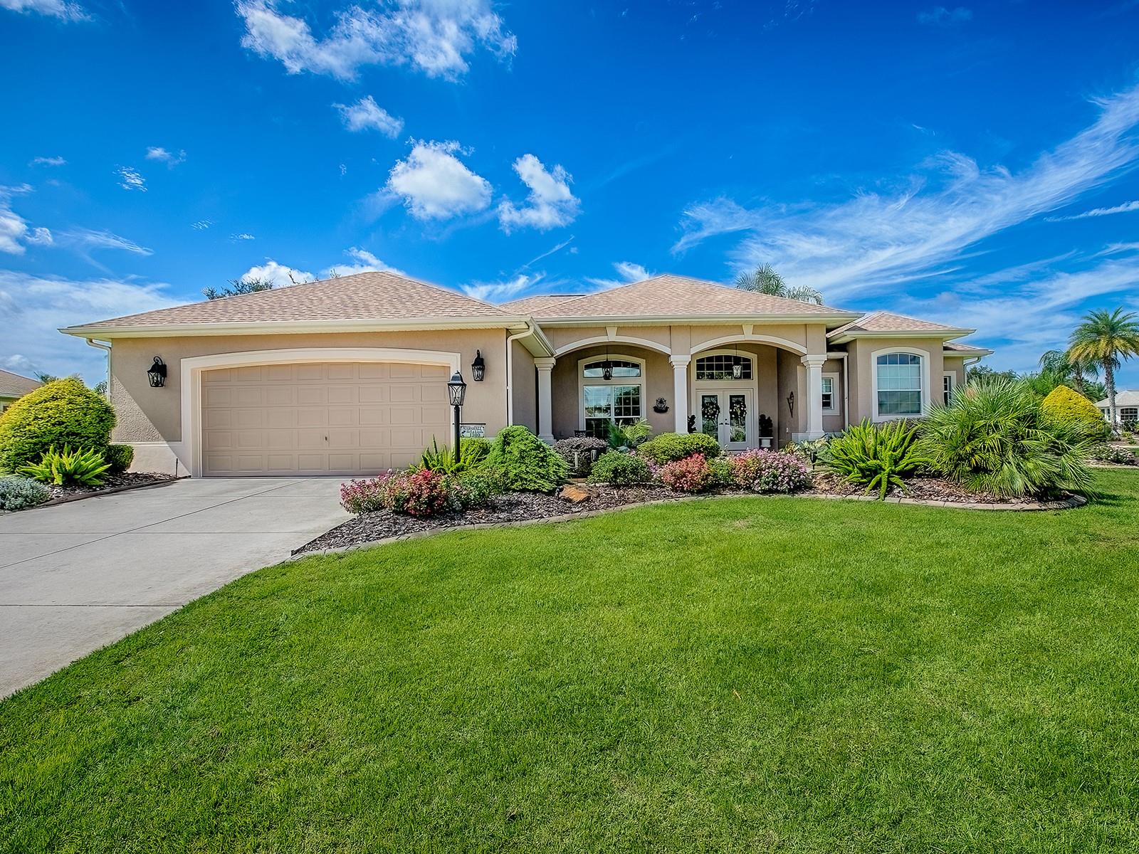 LOVELY CUSTOM ST. SIMON PREMIER home on LARGE CORNER LOT in CUL-DE-SAC with an EXPANDED 2 CAR+ 2 GOLF CART GARAGE, and a BONUS ROOM LOCATED in the VILLAGE of BRIDGEPORT AT LAKE SUMTER, right around the corner from Lake Sumter Landing! Great CURB APPEAL with lush landscaping around the entire home, a large FRONT PORCH, and beautiful DOUBLE LEADED GLASS FRONT DOORS. Upon entering you’ll find CERAMIC TILE flooring in the foyer, formal living room, dining room, kitchen, casual dining area, laundry, and hallways with attractive HARDWOOD in the bonus room and primary bedroom. The NEWER ROOF and HVAC make this lovely home even more appealing! The main living area, kitchen, and family room offers CROWN MOLDING and custom window treatments. The spacious kitchen has light CHERRY CABINETRY, GRANITE COUNTER TOPS, STAINLESS appliances, an island, a large WALK-IN PANTRY, and a pass-thru out to the lanai and birdcage area – so convenient when grilling and entertaining. The formal living room and family room both open with sliding glass doors out to the lanai and outdoor living space. Should you desire, there is plenty of room for a pool and so much PRIVACY with this large corner lot. The 18’x16’ BONUS ROOM is off the family room and was added for a craft room but does have a very large closet and could be used for a 4th bedroom, den, etc. This split floor plan offers you and your guest lots of privacy with the primary bedroom suite on one side of the home and the guest on the other. The primary suite has crown molding, a tray ceiling, 2 WALK-IN CLOSETS with custom BUILT-INS, sliding glass doors that open out to the lanai, and an EN-SUITE BATH! The bath offers a large soaking tub, 2 vanities, GRANITE counter tops, TILED shower, and separate toilet room. The guest rooms have carpet and large closets; the guest bath has a tub/shower and granite counter tops. The laundry room has lots of extra cabinet space, under cabinet lighting, a sink, and FRONT LOAD washer and NEWER BOSCH FRONT LOAD DRYER that do convey with the home. The OVERSIZED 2 car garage has a large stretch to allow space for 2 golf carts. This is a LOVELY home in a great location with homes surrounded by nature and beautiful golf courses! Within minutes you can enjoy entertainment, dining, shopping at LAKE SUMTER LANDING, several RECREATION CENTERS, and Arnold Palmer Legends Country Club with fine cuisine and CHAMPIONSHIP GOLF COURSE. COME SEE ALL THIS HOME AND AREA HAS TO OFFER!