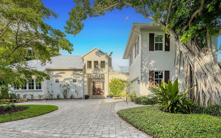 Sarasota West of Trail contemporary home in Oyster Bay Landings, the only gated community in highly desirable Oyster Bay Estates. This secluded neighborhood has only 12 residences with deeded boat docks along a hidden cove on Roberts Bay. Exquisite expression of contemporary style infused with a spirit of serenity and delight. Tall pitched ceilings, oversize sunlit windows, open living spaces, over-garage loft suite with private entry, and private pool courtyard check all the boxes for a formidable forever home. This courtyard pool home provides peaceful privacy inside and out. Every detail was carefully selected and expertly installed such as high ceilings, 8-foot solid-core doors, engineered wood floors, solid-wood cabinets, custom millwork, linear air-conditioning vents, two-step crown molding, dual walk-in closets with custom organization and high-end stainless steel appliances. For convenience and energy efficiency, the home is fitted with impact glass, two tankless gas water heaters, outdoor security camera and three-zone air-conditioning system. Offering 4,030 square feet of living space, the main living space features an open floor plan with cathedral ceiling and cove lighting. A full wall of glass opens to the pool courtyard on the west side, and clerestory windows on the east let in glorious morning light. The open living space flows into a private courtyard oasis with heated pool and spa, covered lanai and outdoor kitchen. The fabulous kitchen has solid wood cabinetry with soft-close mechanism, an oversized eat-in island, and Wolf, Sub-Zero and Asko appliances. The primary bedroom suite features oversized dual walk-in closets with an array of custom organization details. One includes a dressing mirror, hardware with crystal insets, jewelry cabinet with lock, two locked drawers and in-closet washer and dryer. The other has gentlemen’s accessories cabinets. Both have mirrored finishing countertops and automatic LED cabinet lighting. Two additional bedrooms and baths are down the hall from the primary suite. A 23-by-18-foot bonus loft with en-suite bath and private entrance is over the two-car garage. The fantastic West of Trail location is centrally within distance of The Field Club, one mile from Publix, two miles from Sarasota Memorial Hospital, three miles from downtown Sarasota and five miles from Siesta Key Beach. See this warm and welcoming residence that is on-trend and timeless.