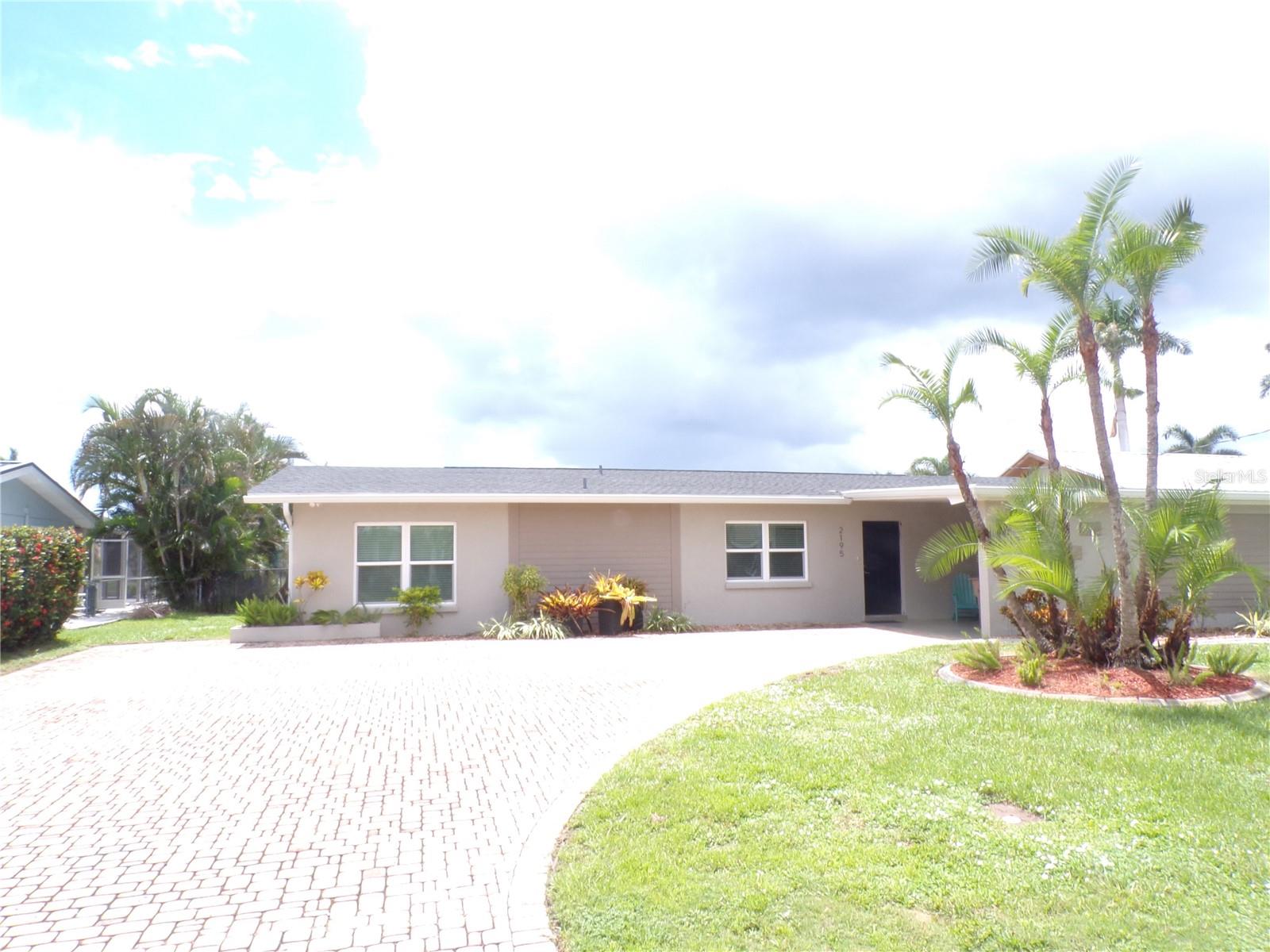 ANNUAL UNFURNISHED 3 bedroom, 2 bath home situated on sailboat waterfront with 80 feet of frontage on wide saltwater canal is a short boat ride to beautiful Charlotte Harbor and then on to the Gulf of Mexico. Kitchen boasts stainless LG appliances with 4 door Fridge, wood cabinetry, and pass through window to lanai for easy entertaining and great view of water. Master suite has walk in closet and updated en suite bath. Beautifully restored Terrazzo flooring and dedicated laundry room with washer and dryer, built in cabinetry and pantry. Open floor plan with triple sliders in the living area for great view of waterway. 2nd and 3rd bedrooms share a "Jack and Jill" bathroom. Spacious brick paved and screened lanai adds to the living area. 7500-pound lift and concrete dock. Nice curb appeal with brick paved driveway, carport, landscape curbing, decorative rock, and mature palms. Proximity to local beaches, dining, shopping, and golf courses makes this property ideal for the Florida lifestyle. This is your opportunity to own a little piece of waterfront paradise!
