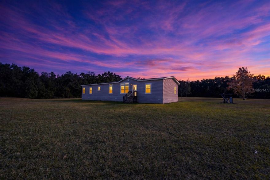 Motivated Sellers!
Welcome to this stunning 4-bedroom, 2-bathroom home nestled on 5 acres of agriculturally zoned land, where space, comfort, and serenity come together. Built in 2020, this expansive 2,280 sq. ft. home offers a modern open layout with thoughtful upgrades and room to truly spread out.

Step inside to a bright, inviting living area centered around an elegant electric fireplace with a stone surround—perfect for unwinding after a long day. The spacious kitchen features a large center island, generous counter space, and ample storage, making it ideal for entertaining or gathering with family and friends.

A separate den provides flexible space for hosting, relaxing, or creating a cozy family retreat. The primary suite is a true escape, offering plenty of room for all your furniture and a spa-like ensuite with dual vanities, a soaking tub, walk-in shower, and walk-in closet.

Three additional bedrooms are comfortably sized—perfect for a growing family, guests, or a home office. The home also boasts a desirable split floor plan and an oversized laundry room with extra storage.

Outside, the property truly shines. Enjoy quiet evenings surrounded by mature magnolia trees, fresh air, and wide-open space. An orange tree adds a charming touch to the landscape, while the expansive acreage offers endless possibilities for gardening, animals, or simply enjoying peaceful country living.

This is a rare opportunity to enjoy modern comfort, natural beauty, and tranquil evenings—all in one exceptional property.