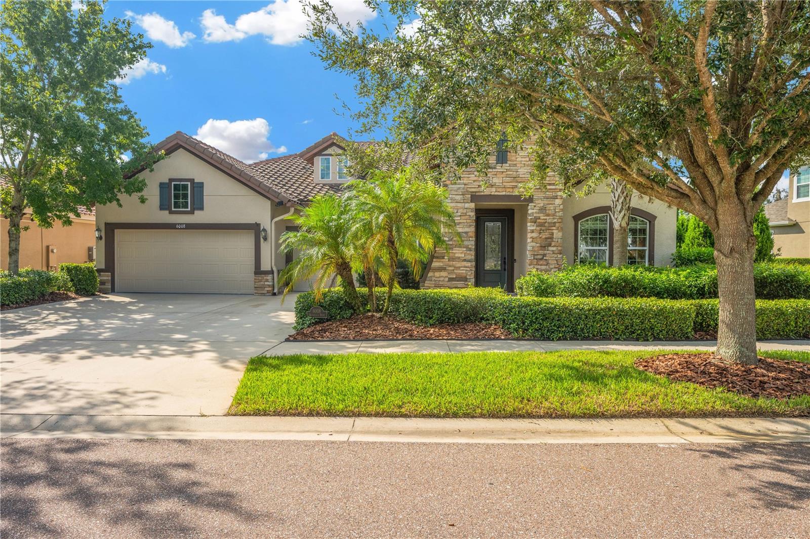 This beautifully upgraded 5-bedroom, 3.5-bath home delivers the perfect blend of style, comfort, and peace of mind in one of Tampa Bay’s most sought-after master-planned communities. Nestled on a quiet conservation lot, this home offers nearly 3,000 square feet of light-filled living space designed for making memories with family and friends. Practical upgrades include a 22kW whole-home Generac generator and hurricane shutters to keep you safe and worry-free during storm season. From the moment you enter through the leaded glass front door, you’ll be welcomed by soaring ceilings, crown molding, shiplap details, and wood-look flooring that flows through the main living areas. The open concept design allows the kitchen, dining, and living areas to function as the heart of the home — perfect for gathering, entertaining, and everyday living.
The gourmet kitchen is a chef’s dream, featuring marble countertops, 42” cabinets, a massive center island with seating, gas cooktop, stainless steel appliances, subway tile backsplash, and a walk-in pantry. The family room is filled with natural light from a wall of windows that frame tranquil views of the conservation area, creating a seamless connection between indoor and outdoor living.
The spacious primary suite is a peaceful retreat with three oversized windows, a spa-inspired bathroom with dual sinks, a soaking tub, a frameless walk-in shower, and an expansive walk-in closet. Secondary bedrooms are generously sized, with one featuring its own private bathroom — perfect for overnight guests or multigenerational living.
Step outside to your private backyard oasis. The oversized 55’ x 20’ screened paver lanai offers multiple sitting areas, a built-in outdoor kitchen, cozy fireplace, and retractable awning — ideal for al fresco dining, hosting friends, or simply enjoying your morning coffee while watching nature unfold just beyond your yard.
The 3-car garage is more than just a place to park — it features a sleek epoxy-coated floor, utility sink, and a stainless steel refrigerator, offering both function and style. The home is also fully cable-ready, making it easy to stay connected and entertained.
Living in FishHawk West means enjoying award-winning amenities, including resort-style pools, fitness centers, sports fields, playgrounds, scenic walking trails, and top-rated schools. The community offers a true sense of neighborhood living while keeping you close to shopping, dining, and commuting routes.
This home offers everything — privacy, luxury finishes, peace of mind, and a vibrant community lifestyle. Seeing is believing, schedule your private showing today and make this dream home yours!