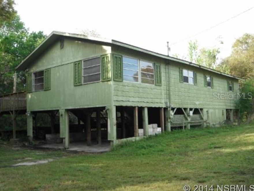 A sanctuary of your own on this nearly one acre lot!  Raised prefab home with parking and utility underneath.  Fixer Upper.  Cash offers due to condition.  All room sizes are approximate.  Freddie Mac HomeSteps home.  Buyer to pay doc stamps on deed.  This property is eligible under the Freddie Mac First Look Initiative until 5/1/2014. ;Water: City