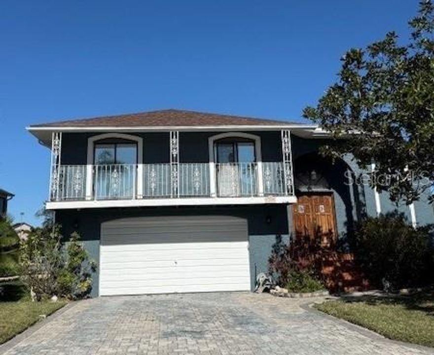 Elevated waterfront living awaits in the highly desirable Gulf Harbors Woodlands Community of New Port Richey! This lovingly maintained 3-bedroom, 3-bath home offers 1,922 sq ft of main-level living, plus an expansive lower level, for a total of 4,652 sq ft. Situated on 66 feet of serene waterfront, the property includes a 12,000 lb boat lift with water and electric, a fish cleaning station, and additional davits—perfect for multiple vessels. Enjoy tranquil canal views with rare privacy and peaceful surroundings. Step inside to a truly open floor plan where the kitchen, dining, and living areas flow seamlessly together—a perfect great-room layout for relaxed living and entertaining. Double sliding glass doors from the main living area open to the rear balcony, overlooking your backyard and the scenic canal waters. The great room is anchored by a stunning large stone fireplace, providing a warm and inviting focal point. One of the home’s standout features is its PRIVATE ELEVATOR, offering effortless access between levels and making daily living, groceries, and entertaining a breeze. Additionally, the upstairs laundry room adds convenience and practicality to everyday life. The split-bedroom design provides an ideal layout for privacy. The primary suite boasts canal views, a spacious en-suite bath, and a walk-in closet. The secondary bedrooms are located on the opposite side of the home, each with access to a front-facing balcony, and share a full bathroom. The lower level features a 4+ car oversized garage, perfect for vehicles, storage, tools, kayaks, fishing gear, and more. It also includes a bonus room, storage space, and a full 3-piece bathroom. Key updates include a new roof (2022) and A/C (2018). This home is in original condition and has been lovingly maintained, offering a solid, move-in-ready foundation. It’s full of potential for the new owner to update and personalize to their own taste, creating the perfect waterfront retreat tailored to their lifestyle. Boaters will appreciate the direct access to the Gulf Harbors North Channel, with no fixed bridges, just minutes to open waters! Gulf Harbors Woodlands is a deed-restricted community offering a waterfront heated community pool, clubhouse, and private boat ramp. The neighborhood is just minutes from vibrant downtown New Port Richey!  Downtown NPR offers many fun activities including Sims Park, eclectic restaurants, and shopping. Tampa International Airport is only about 35 minutes away, with medical facilities nearby and countless “must-do” adventures in Tarpon Springs, Dunedin, and Clearwater. This home combines location, lifestyle, accessibility, and waterfront living—all in one remarkable package. Schedule your showing today!