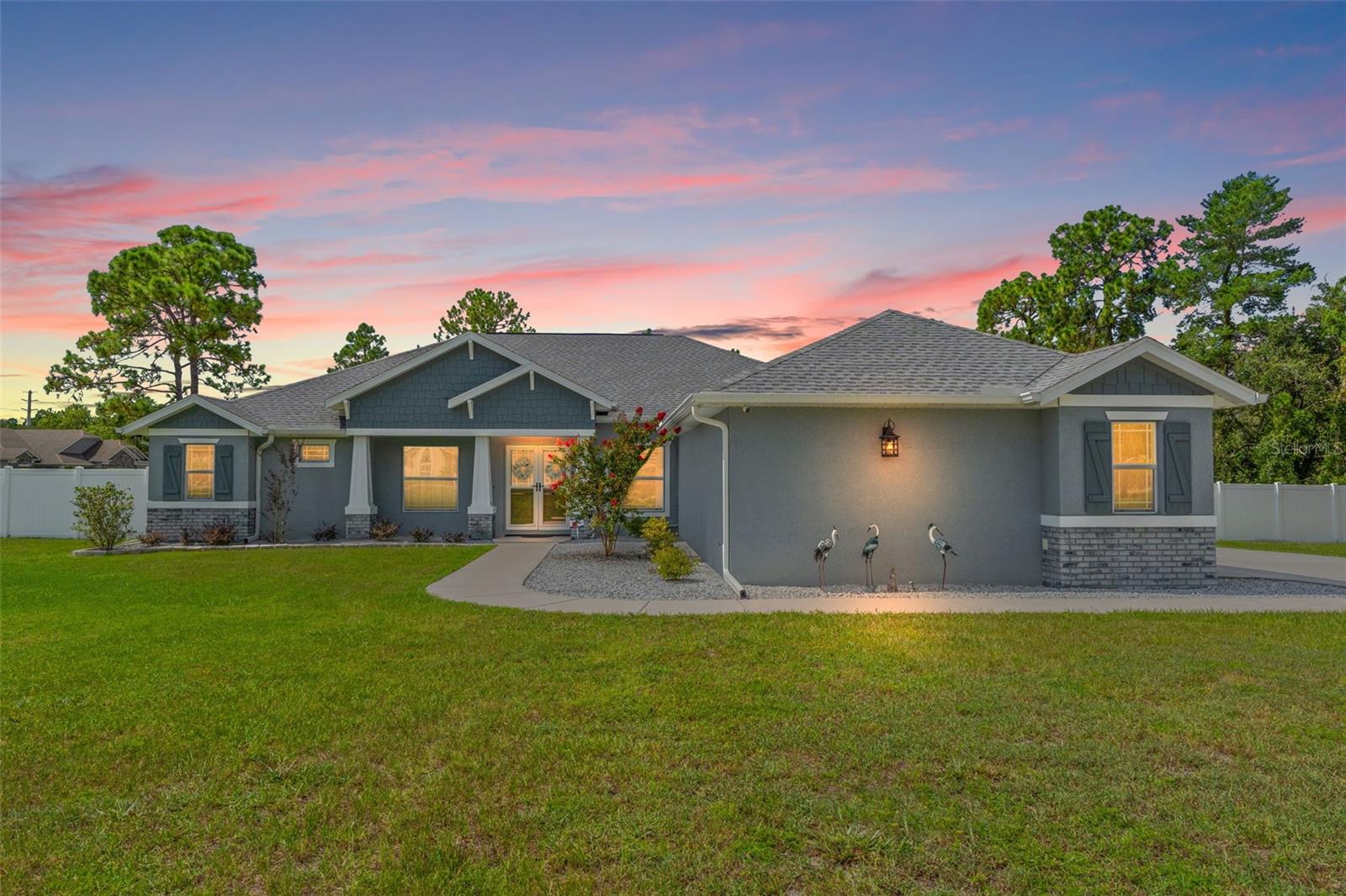 2022 BUILT + 1.3 ACRES + HUGE Pool! This one has it all - 2022 BUILT + 1.3 acres (FULLY FENCED WITH A 6-FOOT PRIVACY FENCE + 2 DOUBLE GATES) + 3 BEDROOMS + OFFICE + FLEX ROOM OFF OF THE PRIMARY SUITE + 3 FULL BATHROOMS (including a guest en-suite) + 3-CAR SIDE-ENTRY GARAGE + one of the BIGGEST residential POOLS in Weeki Wachee (20x40!). The yard is wide open—completely cleared and big enough to literally play football in. And the pool? A total showstopper. A 20'x40' SALTWATER POOL with a huge SUN SHELF, 3 WATERFALLS, a massive paver deck, LED color-changing LIGHTS, and a HEATER/CHILLER so you can swim year-round at your perfect temp. It's basically your own private resort. Inside, the great room floorplan is open and bright with pool views from nearly every room. The formal dining room has a BUILT-IN BAR AREA, and the kitchen is oversized with wood cabinetry, granite countertops, subway tile backsplash, and the cutest COFFEE BAR nook. The primary suite features tray ceilings, his & hers closets, a spa bath with soaking tub + WALK-IN SHOWER with dual shower heads, and an 11x14 FLEX SPACE perfect for a gym, nursery, or second office. Upgrades? Already done: 5-TON 2-stage variable AC (2023), 17-zone SPRINKLER SYSTEM, whole-house gutters (2023), dual hurricane storm doors, energy-efficient dual-pane windows, security system with surveillance cameras, tile flooring throughout, and upgraded baseboards. Plus a large covered patio for outdoor living. All this with NO HOA, NO CDD fees, and NO flood zone. And let's talk location - you're in Weeki Wachee, home of the world-famous mermaids and crystal-clear springs for kayaking, paddleboarding, and swimming. Just minutes to boating and waterfront dining at Hernando Beach, with easy access to Tampa, St. Pete, and the Gulf beaches. Zoned for the area's newest schools, too. YOU WILL WANT TO SEE THIS ONE IN PERSON.