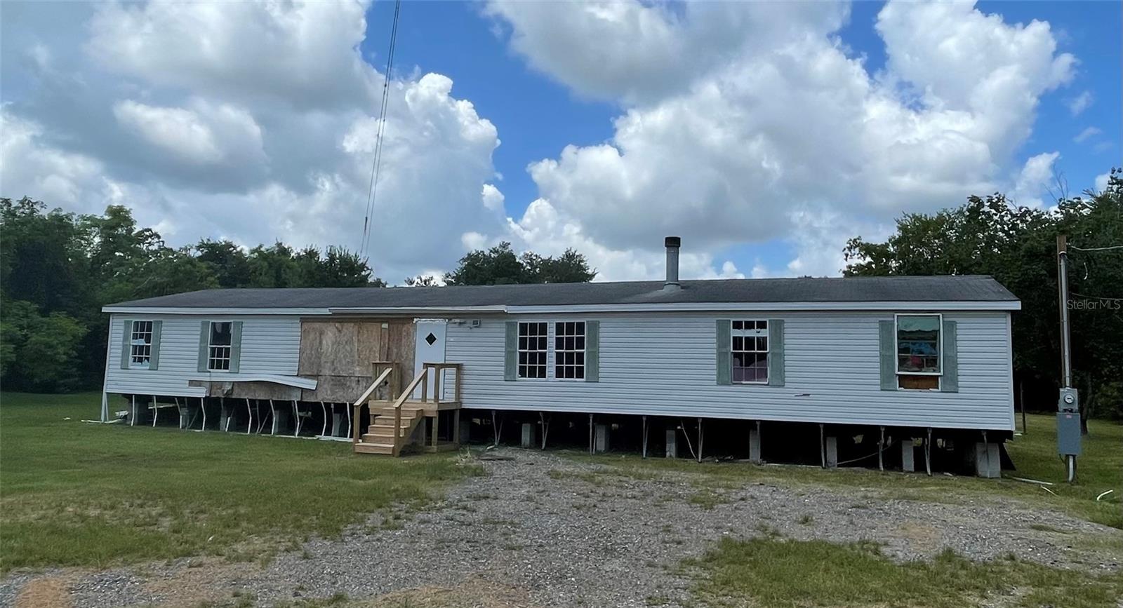 FIXER UPPER Partially started, waiting for you to make her new again. Vacant and brush cleared. Extra Large 1999 manufactured home, 5 bedroom 2 bath with fireplace on over 3/4 acre. Near Lakeland AND Auburndale shopping and restaurants Room sizes are approximate. No survey or seller disclosure. Owner financing available with 10% down!