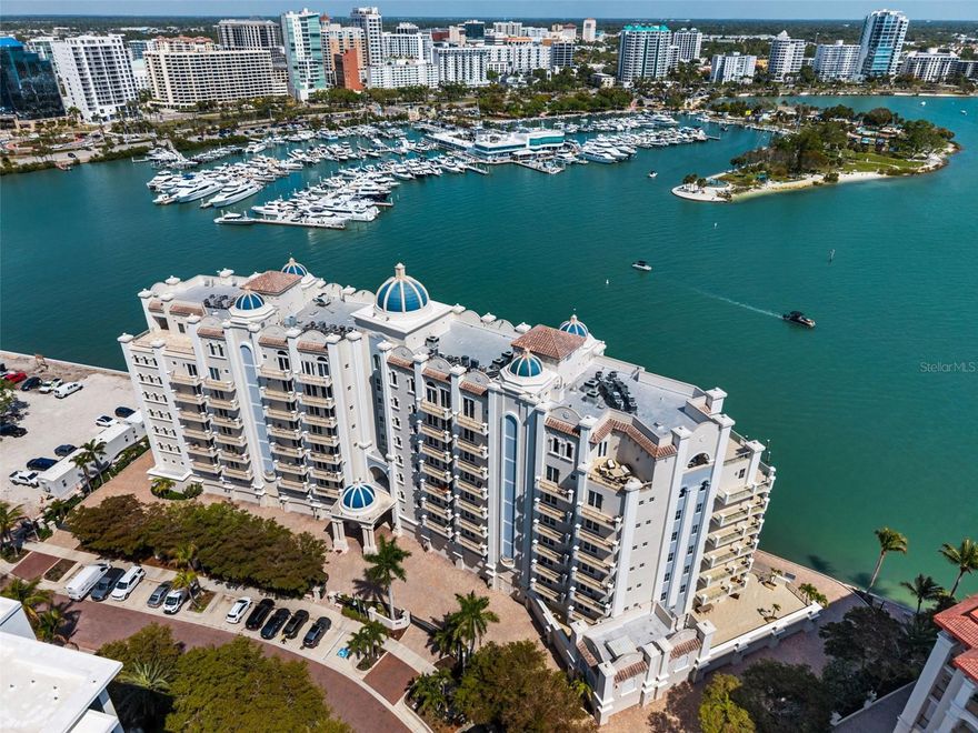 Commanding breathtaking panoramas of Sarasota Bay, the downtown skyline, and the barrier islands beyond, this exceptional 3-bedroom, 4.5-bath residence at La Bellasara enjoys a rare 7th-floor vantage point on coveted Golden Gate Point. Encompassing over 3,490 square feet and finished with neutral marble floors throughout, the residence lives like a private waterfront home—blending expansive interiors, refined design, and effortless access to the heart of downtown Sarasota. The primary suite is a true retreat, distinguished by two completely separate his-and-hers bathrooms, offering an uncommon level of space and privacy. A private elevator opens to an elegant entry foyer, setting the tone for interiors defined by high ceilings, crown molding, and a light, coastal palette. Walls of glass frame sweeping water and city views while filling the open-concept living and dining areas with natural light. The spacious great room flows seamlessly to expansive bayfront terraces, creating an ideal setting for both entertaining and everyday living. The gourmet kitchen is thoughtfully appointed with a large center island, breakfast bar, custom cabinetry, and premium appliances including a 6-burner Dacor gas range, Sub-Zero refrigeration, Wolf oven and warming drawer (new in 2025), and convection microwave. Designed to connect effortlessly with the main living areas, it offers both function and style for casual dining or hosting. The primary suite enjoys direct terrace access along with dual walk-in closets and the rare distinction of two separate full bathrooms, creating a true private retreat. Two additional guest suites, each with en-suite baths and access to private terraces, provide comfort and privacy for family and visitors alike. Outdoor living is equally compelling, with multiple terraces that capture panoramic bay and skyline views. A summer kitchen and built-in gas grill enhance the experience, offering the perfect backdrop for sunset gatherings or quiet evenings overlooking the water. La Bellasara is an intimate, gated waterfront community of just 28 residences, offering the privacy of a single-family home with the ease of luxury condominium living. Residents enjoy a full suite of amenities including concierge services, a bayfront heated pool and spa, fitness center, theater and social rooms, and a courtesy day dock. Each residence includes a private two-car garage, and specific to this residence a deeded boat slip. Ideally located just moments from downtown Sarasota, St. Armands Circle, and the area’s renowned beaches, this is a rare opportunity to enjoy refined waterfront living in one of Sarasota’s most sought-after bayfront communities.