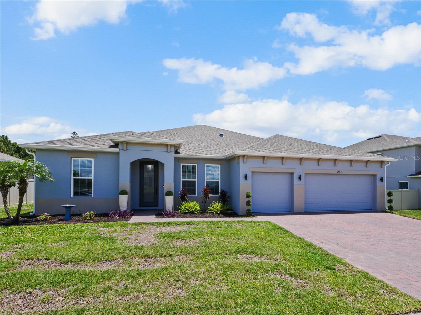 Now this is what you have been waiting for! This beautiful spacious home is calling your name. Owner added special touches throughout such as engineered wood floors and porcelain tile in main areas. Beautiful unique white tiled wall at the entrance to the large laundry room with granite countertops/ Laundry is pre-plumbed for wet sink. Gourmet kitchen is a chefs dream with an awesome view as it opens into the stunning great room which also has a view to the lanai and very large private back yard. Brick pavers in front and extra large brick paved pad in the rear, perfect for BBQ's etc. Neighbors on both sides have fenced in their property so you would only need to fence the rear and add a pool should you choose to do so. Owner had higher trey ceilings installed which makes for a very grand feel in the great room. Master is very nice with an ensuite bath and double vanities and a huge walk in closet. Washer, dryer and fridge do not convey but could be negotiated. Come and get it!!