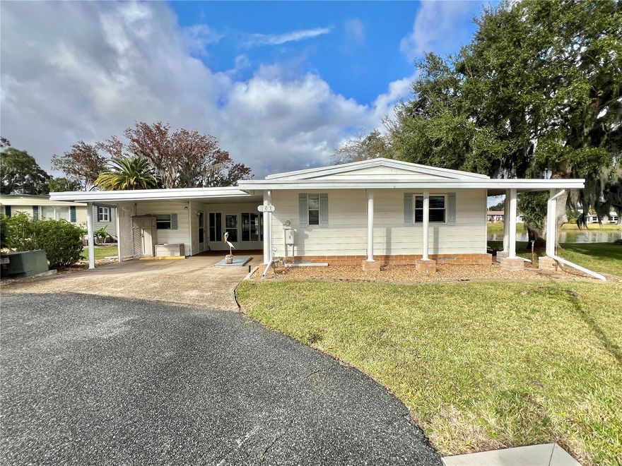 Here is a rare opportunity to own a waterfront home at Fountain Cove with breathtaking views of the lake and the beautiful Hawthorne clubhouse. Tucked away on a private cul-de-sac, this move-in-ready home offers peaceful surroundings and stunning scenery.

Inside, the home features a spacious kitchen, living room, and dining area that flow together seamlessly and connect to a bright and airy living space, perfectly positioned to take in the lake views. Upgraded windows and a sliding glass door allow for abundant natural light while enhancing comfort and energy efficiency.

Notable features include an underground storm shelter for added peace of mind, a membrane roof installed in 2011, and a heat pump replaced in 2009.

With its prime location, beautiful setting, and solid updates, this home offers a unique blend of comfort, privacy, and scenic Florida living. Don’t miss the chance to make this special waterfront property your own.
............Hawthorne at Leesburg is an active, resident owned, 55+ cooperative, waterfront, gated community, with beautifully landscaped grounds, lakes with illuminated fountains and a relaxing and comfortable gazebo. The affordable monthly maintenance fee of $397 includes water, sewer, lawn mowing, private emergency services and storage space for recreational vehicles, boats, trailers and much more! The beautiful clubhouse is complete with a full-time program coordinator, more than 100 different activities and seating for 550. It has a hospitality lounge, card rooms, craft rooms, billiard room, fitness center, library, fine arts room and many more. There is excellent fishing, outdoor geo-thermally heated pool and two enclosed therapeutic pools. Hawthorne boasts a private marina monitored by an electronic security system with over 120 boat slips and access to the Harris Chain of Lakes and beyond.