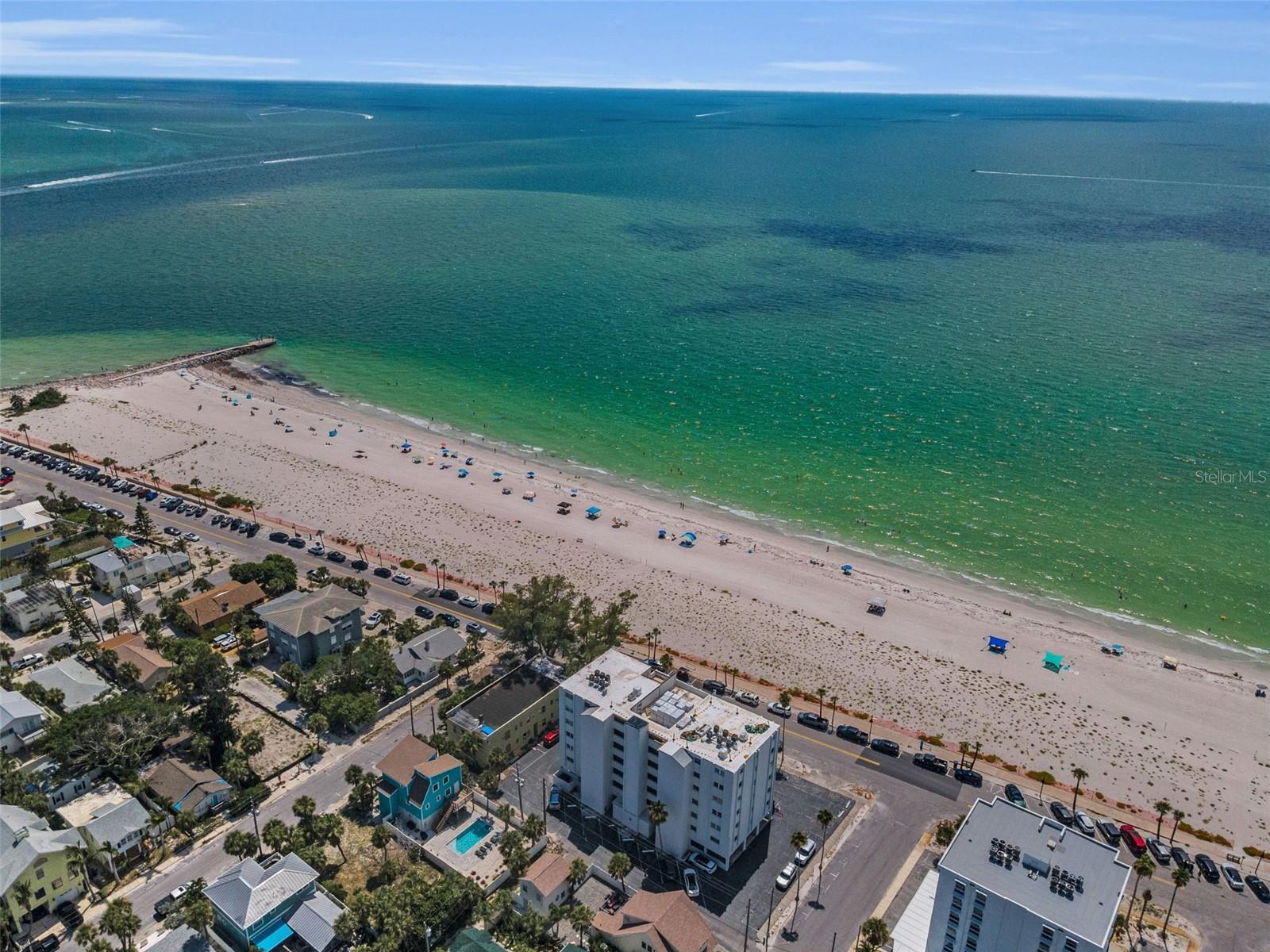 Enjoy coastal living at its finest! This charming 2-bedroom, 1-bathroom condo is located just steps, yes STEPS, from the sparkling Gulf of America. This cozy unit offers the ultimate in beachfront living; the open-concept floor plan provides an inviting living space with stunning views of the beach and the turquoise waters. Large sliding glass doors throughout allow natural light to pour in, creating a bright and airy atmosphere. The well-appointed kitchen and spacious living area are perfect for relaxing or entertaining. The primary bedroom offers a peaceful retreat with plenty of closet space, while the second bedroom is perfect for guests, a home office, or a cozy den. The shared bathroom is tastefully updated, providing convenience and comfort. With direct beach access just outside your door, you’ll have the perfect spot to watch sunsets, enjoy long walks along the shore, or take in the relaxing coastal vibes. You don't even need to leave the comfort of your home to enjoy a beautiful sunset, just step out onto your balcony and soak in the ocean air. The condo is situated in a well-maintained building with convenient amenities, including on-site parking and an elevator for easy access. Whether you're seeking a vacation getaway or your dream beach home, this condo offers everything you need. Don’t miss out on this rare opportunity—schedule your private showing today!