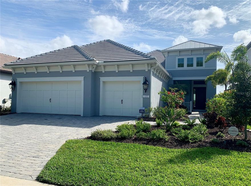 You won't want to miss this one......Indulge in the epitome of lakeside luxury at The Alcove at Waterside by Neal Signature Homes, an exclusive enclave within the vibrant Waterside District of Lakewood Ranch. This stunning residence offers three bedrooms, three full baths, a private den, and 2432 square feet of thoughtfully designed living space with IMPACT RESISTANCE GLASS AND SLIDERS! This beautiful home has a private saltwater pool with LED lights and a large covered lanai area measuring 28 x 17 feet. Plumbed for an outdoor kitchen and comes with electric hurricane screens to give you that peace of mind you are wanting. 
Inspired by a Coastal architecture, the home showcases elegant stucco exterior, a classic tile roof, and refined architectural details. Inside, elevated design touches abound, including custom ceiling treatments, designer wallpaper, and plantation shutters, creating a sophisticated yet relaxed coastal ambiance.
Seamlessly blending indoor and outdoor living, custom 10-foot-high by 12-foot-wide sliding glass doors open to the outdoor living space and frame picturesque views of Blue Heron Lake, filling the home with natural light. Enjoy evening sunsets like you have never seen from your beautiful lanai overlooking the lake.
Additional upgrades include a whole-house Kohler generator for peace of mind, mini-split air-conditioning system in the garage, insulated garage doors, custom ceiling treatments inside and out, automatic sun shade, shell stone pavers that are cool to the touch and additional storage in the garage.
Perfectly located just one mile from the coveted Waterside Place Village, residents enjoy easy access to waterfront dining, boutique shopping, farmers markets, and community events. Center Point at Waterside is only 1.5 miles away, offering even more popular lunch and dinner destinations along with everyday conveniences.
With breathtaking lake views, thoughtful upgrades, and an exceptional location in one of Lakewood Ranch’s most desirable areas, this remarkable home offers luxury living and lifestyle at its finest — and so much more to discover.