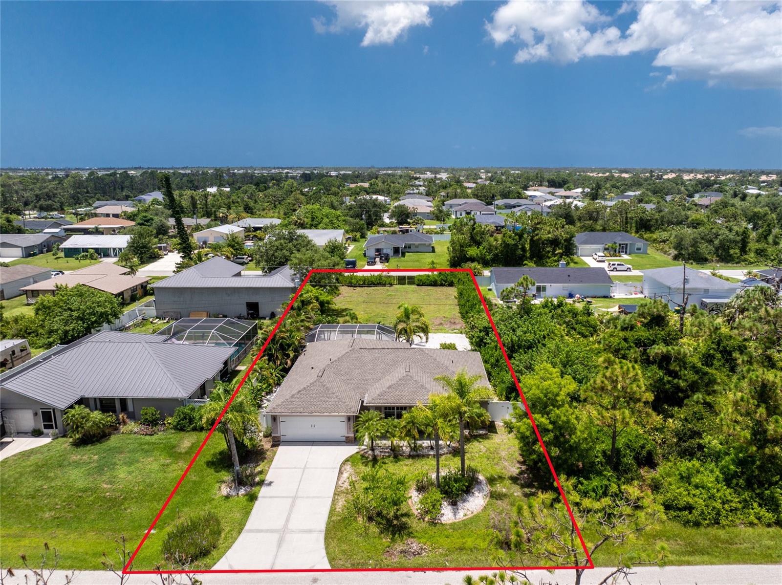 One or more photo(s) has been virtually staged. Need room for your toys and family? Come see this desirable 2011 built pool home on a double lot with frontage on two roads! No HOA or deed restrictions and in preferred flood zone X so no flood insurance should be required! This spacious property is ideal for a family who needs additional land for business or equipment storage or parking for your boat or RV. Keep the second lot open for preserved privacy or build a garage or another home for extended family! Recent updates include a brand new roof installed this year, fresh interior paint throughout, lanai screens replaced, new dishwasher and microwave and professionally cleaned flooring and grout. This inviting open concept home is light and bright and offers a split bedroom plan. The kitchen area is ideal for entertaining and offers a large central island with granite counters and a closet pantry and the dining area accesses the lanai and pool. The spacious 38x32 screened lanai offers pavers around the pool and spa with a tropical view of the mature palm trees and landscaping throughout the property. The primary bedroom suite is also accessed by the lanai and has a spacious walk in closet with lots of shelving. The luxurious primary bathroom has a large tiled walk in shower with dual vanities. The main bathroom has a tub/shower combo and is located in between the other two bedrooms on the opposite side of the house. Enjoy the convenience of motion detected light switches throughout the home to save on electricity and a central inside laundry room. The back lot has a gated entrance and is cleared and ready for whatever you're dreams can imagine. Great location just minutes to Englewood's pristine beaches on Manasota Key and near several shopping plazas, medical facilities, bars & restaurants, marinas & golf courses and centrally located in between Sarasota and Fort Myers! Come see this unique property for yourself in person or request a virtual showing!