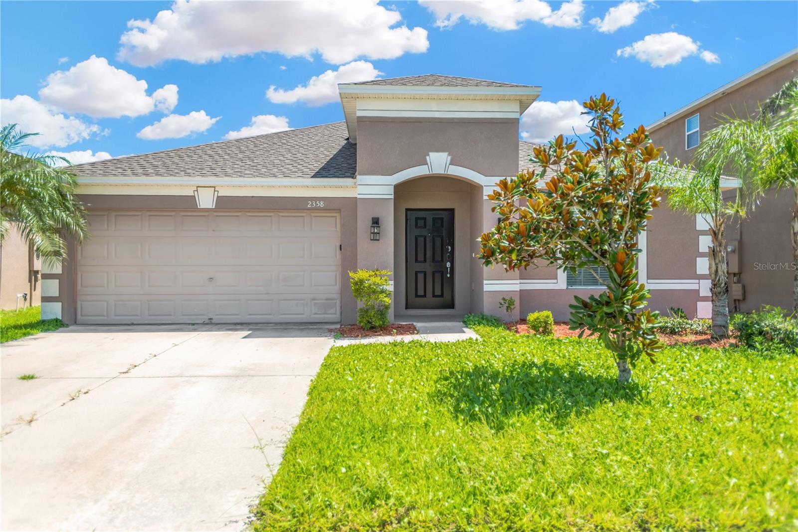 Welcome to 2358 Dovesong Trace Drive, a beautifully maintained 3-bedroom, 2-bathroom home with a den, located in the highly sought-after gated community of Hawks Point in Ruskin, FL. Built in 2015, this spacious single-story residence offers over 2,000 square feet of living space and features a thoughtfully designed split floor plan ideal for privacy and functionality. As you enter, you’re greeted by a formal living and dining room combination that leads into a bright and open family room—perfect for gatherings and daily relaxation. The large kitchen is a chef’s delight, complete with granite countertops, stainless steel appliances, ample cabinetry, a walk-in pantry, and an oversized island with breakfast bar that seamlessly connects to the cozy dining nook and family room. French doors open to a versatile den or office that could easily serve as a fourth bedroom, media room, or playroom. The spacious owner’s suite boasts tray ceilings, a walk-in closet, and an en-suite bathroom with dual sinks, a soaking tub, and a separate glass-enclosed shower. Secondary bedrooms are located on the opposite side of the home and share a full bathroom, providing ideal separation for family or guests. Enjoy indoor-outdoor Florida living with a fully fenced backyard featuring low-maintenance PVC fencing and a covered, screened lanai that offers a peaceful space to relax with no rear neighbors. Additional features include high ceilings, ceramic tile and laminate flooring in main living areas, and ceiling fans throughout. With a transferable warranty for energy-efficient comfort. The two-car garage provides extra storage and convenience, while the lushly landscaped front yard offers charming curb appeal. Located in a community that offers resort-style amenities—including a gated entrance, community pool, fitness center, playground, clubhouse, and dog park—this home is close to shopping, dining, schools, and major highways like US-41 and I-75, offering easy access to Tampa, Sarasota, and Gulf beaches. Whether you're working from home, entertaining, or just looking for a quiet retreat, this move-in-ready gem has it all. Schedule your private showing today and come see why this home stands out in one of Ruskin’s most desirable neighborhoods.