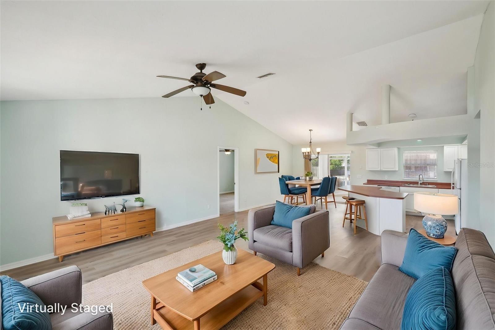Bundled service pricing available for buyers. Contact the agent for details. ***ASSESSMENTS PAID***NO FLOOD ZONE***HIGH ELEVATION***This beautiful 3-bedroom, 2-bathroom 2-car garage home is located in the heart of Cape Coral and offers over 1,400 square feet of light-filled living space. All assessments are paid! With a new roof (2023) and all new luxury vinyl plank flooring (2023), this home is move-in ready and designed for low-maintenance living. The open concept floor plan with soaring cathedral ceilings creates an airy feel, while the split bedroom layout adds privacy for guests or family.
The kitchen features new appliances, a large island with breakfast bar seating, and plenty of cabinet space, flowing effortlessly into the living and dining areas. The spacious primary suite includes a dual vanity, soaking tub, and separate shower. Two additional bedrooms share a full bath, and a dedicated laundry room adds convenience.
Enjoy the outdoors on the south-facing screened lanai overlooking the fully fenced backyard, perfect for entertaining. Additional features include a 2-car garage, no HOA, no flood zone, and the home is elevated higher than the neighboring properties—ensuring it has never experienced water intrusion. Lake Saratoga and Sunsplash Waterpark are nearby, and the home is just a short distance to grocery stores, retail, and more—making this Cape Coral gem both convenient and secure!