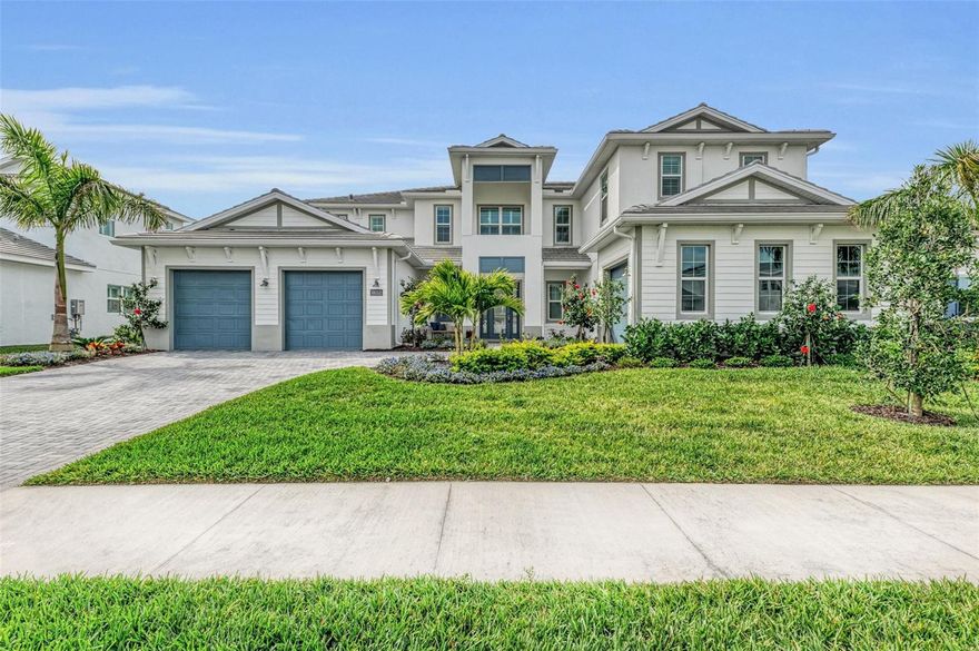 Experience the pinnacle of luxury living in The Isles, a gated community nestled between The Lake Club and Concession. Presenting a magnificent masterpiece completed in June 2023, this home showcases the Fullerton floor plan, the largest in the community, boasting nearly 5,000 square feet of living space. With a unique Bonus Room, 4-bedroom en-suites, an Office, and Open Loft, this residence caters to every need. Situated on a serene cul-de-sac street, this waterfront homesite offers unparalleled privacy with no rear neighbors and southern exposure. Upon arrival, you're greeted by two charming front porches and an upgraded glass front door. Step inside to be captivated by the grandeur of the gathering room, featuring a soaring 21-foot tray ceiling, a towering built-in wall unit, and a row of sliding glass doors overlooking the expansive covered lanai. The outdoor oasis boasts an outdoor kitchen, tongue and groove ceiling, and a 35x18 saltwater-heated pool/spa complete with extra jets, bubblers, and the soothing sounds of a 3-tiered waterfall. Indulge your culinary passions in the expansive kitchen, equipped with quartz countertops, a popular single bowl sink, stainless-steel appliances, a vented hood, and upgraded cabinets with staggered uppers, soft close mechanisms, pullout shelves for added convenience and a large pantry. The impressive island features navy cabinets with extra storage and ample workspace for meal preparation, entertaining, and seating. The separate dining room, adorned with multiple windows overlooking the pool area, is perfect for hosting intimate or large gatherings. Conveniently located off the kitchen, you'll find a powder bathroom, a spacious laundry room, and a built-in drop zone area leading to the two-car garage with a 4’ extension. The Owner’s Retreat has been extended to provide additional space for comfort, offering two large closets, a tray ceiling, and plantation shutters found throughout the home. The elegant bathroom highlights a stunning wavy wall, complemented by Cambria quartz countertops, which are also featured in other guest bathrooms. In the west wing on the lower level, a tucked-away den/office offers utmost privacy next to a Guest bedroom with a full bath and a one-car garage. Upstairs, newly installed carpeting, has an open loft area bringing in natural light through the picturesque windows. Additionally, there are two more Guest Bedroom En-suites, a Bonus room that could serve as a 5th bedroom and has a fifth bathroom. This home is equipped with top-notch features including crown molding in most rooms, 8’ doors, a whole house generator, reverse osmosis system in the kitchen, water softener system, in-wall pest system, spray foam insulation, remaining transferable builder warranties and more. All mounted televisions and patio furniture are available for purchase by separate agreement. Residents of The Isles enjoy access to an impressive 65,000 square foot clubhouse, pickleball/tennis courts, a basketball court, playground, state-of-the-art fitness center, yoga room, resort-style swimming pool and spa, boardwalk, fishing pier, playground, and dog park. Seize the opportunity to call home to the #1 master-planned community catering to all ages! With 150 miles of parks/trails, organized activities, and just moments away from restaurants, world-class beaches, the UTC shopping district, top-rated schools, and beyond, this opportunity is not to be missed!