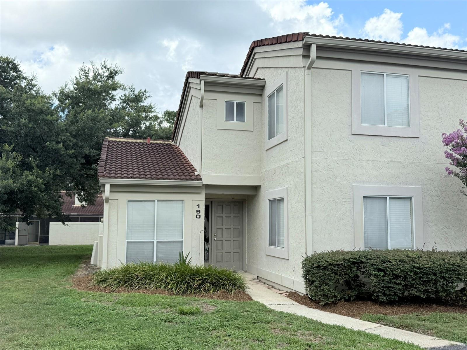 Lovely end-unit home is situated in the Sabal Point Community, conveniently located near Wekiva Springs with easy access to I-4 and many amenities. The vaulted ceilings in the main living area make the home feel both spacious and cozy at the same time. A bedroom and full bathroom are located on the main floor, while the stairs to the second level will take you to the primary suite with walk-in closet and updated bathroom. The screened Lanai provides a shaded sanctuary to relax, while a pavered patio provides an outdoor area to bask in the sun. Association fee includes water service.