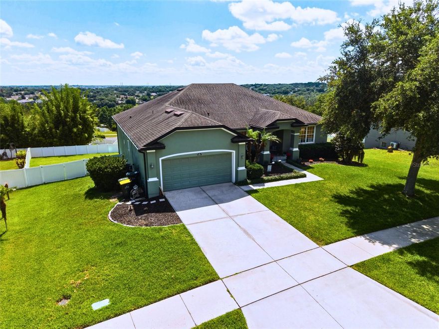 Rare Clermont Basement Home with Views & Multi-Generational Layout! Tucked away on an expansive, elevated 0.42-acre lot in the highly desirable Lost Lake Reserve community, this beautifully maintained 5-bedroom, 3-bathroom residence delivers an astonishing 4,856 square feet of flexible living space—including a spectacular walk-out basement. The main level immediately impresses with beautiful unified flooring that flows seamlessly throughout, enhancing the home's open, spacious feel. This level features soaring high ceilings, dedicated office and dining spaces, and a bright family room that flows directly into a massive eat-in kitchen boasting 42” cabinets, beautiful granite/epoxy countertops, custom backsplash, and stainless steel appliances. Step out onto the screened-in balcony to take in Clermont's rolling hills, or enjoy front-row seats to spectacular views of coastal rocket launches.
The primary suite serves as a truly private space, featuring scenic views, dual walk-in closets, and a spa-like en suite with granite/epoxy counters and a jetted garden tub, while the second and third bedrooms are perfectly situated upstairs for a traditional family layout. Downstairs, the massive walk-out lower level is an absolute game-changer for buyers seeking a high-end multi-generational setup, guest wing, or the ultimate entertaining zone, complete with a second fully equipped kitchen, a dedicated eating area, two oversized bedrooms, and a full bath. The lower level opens out to a fully fenced backyard, offering a private and secure oasis for pets and play.

Built with maximum energy efficiency in mind—including a radiant barrier attic, solar panels, and an advanced whole-house water treatment system—this home offers an ultra-convenient location just steps from Lost Lake Elementary, East Ridge Middle, and East Ridge High. Residents enjoy exceptional Lost Lake community amenities, including a sparkling community pool, 2 playgrounds, and scenic lakeside walking paths—all with a very low HOA fee. Situated just minutes from Clermont's premier dining, shopping, and major commuter routes, this property truly has it all. Schedule your private tour today to experience the scale, versatility, and views of this exceptional home!