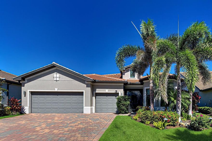Welcome to this exceptional STONEWATER POOL estate home, where design meets modern comfort in Islandwalk, one of Wellen Park’s most sought-after communities. This beautifully appointed residence offers 3 bedrooms, 3 bathrooms, a versatile den, and a spacious 3-car garage. Step inside to discover HIGH CEILINGS, elegant CROWN MOLDING throughout the main living areas, seamless PLANK TILE flooring—no carpet—and CUSTOM LUTRON REMOTE-CONTROL SHADES in the great room and primary bedroom.

The open-concept layout centers around a gourmet kitchen with crisp white cabinetry, high-quality stainless steel appliances, a generous CUSTOM WALK-IN PANTRY, and a large island with pendant lighting. Adjacent to the kitchen, a breakfast nook offers tranquil water views through TWO SLIDER DOORS and flows into the NATURAL LIGHT-FILLED great room. Here, COFFERED CEILINGS, recessed lighting, a WINDMILL CEILING FAN, and TRIPLE SLIDERS create an inviting space for entertaining or relaxing, seamlessly connecting to the expansive COVERED and SCREENED lanai.

Step outside to your private oasis featuring a HEATED SALTWATER POOL with SPA, ceiling fan, remote-controlled STORM SHADES, and peaceful WATER VIEWS—perfect for year-round enjoyment. The luxurious primary suite showcases a TRAY CEILING with crown molding, tile flooring, ceiling fan, and en suite bathroom behind DUAL SOLID DOORS. Inside, enjoy a generous tiled shower, dual vanities, and a CUSTOM WALK-IN CLOSET designed for style and storage.

The guest bedroom offers comfort with a ceiling fan, built-in closet, CUSTOM WINDOW SHADES and access to a bathroom with bathtub, linen closet, and soft neutral tones. The third bedroom is bathed in natural light from turret windows and is near a third bathroom with tiled tub and white cabinetry. A versatile flex room adds functionality—ideal for a home office, craft space, or extra bedroom—and includes a BARN DOOR, crown molding, CUSTOM WINDOW TREATMENT, and ceiling fan.

The spacious laundry room features LG washer and dryer, vanity sink, and crown molding for a polished finish. For peace of mind, the home includes IMPACT WINDOWS THROUGHOUT and a 500-GALLON PROPANE TANK for the GENERATOR. All mounted TVs convey! The 3-CAR GARAGE boasts EPOXY FLOORING and OVERHEAD STORAGE RACKS for optimal organization.

Living in Islandwalk means enjoying resort-style amenities year-round: geothermal pools, Har-Tru tennis courts, pickleball, bocce ball, lap pools, spas, playground, basketball court, dog park, two state-of-the-art fitness centers, a 24-hour staffed gate, and on-site HOA staff seven days a week. Residents also enjoy a pavilion with BBQ grills, a library, and a vibrant social calendar.

Golf carts are permitted and can travel beyond Islandwalk into Wellen Park via a resident-only gate, offering exclusive access to Downtown Wellen Park. There, enjoy a lively Marketplace anchored by Publix, the Atlanta Braves Ballpark, restaurants, and entertainment. Conveniently located just four miles from I-75, this home offers easy access to pristine Gulf beaches, regional airports, and the charm of Historic Venice Island with its boutique shopping, dining, and cultural events.