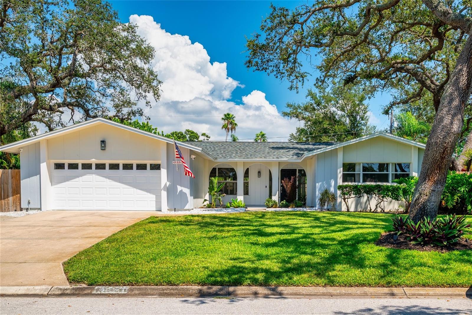 Exquisite Bay Hills Beauty! All the "I Wants" plus all the finishing touches! Spacious - over 2000sq. ft 3 br., 2ba, split plan, 2 car garage pool home with tropical fenced yard set on 92'X110' lot in gorgeous, tree lined subdivision off 102nd & Oakhurst! Charming entry opens to living room and/or spacious family room, then flows through to brand new kitchen with quartz counters and sparkling stainless steel appliances. This overlooks the breakfast room with glimpses of screened porch through french doors and relaxing pool and private newly fenced yard beyond. There is even a fire pit and conversation area carved out in the tastefully landscaped grounds which also feature extra parking on the side for your camper or boat! The Primary bedroom is super spacious with closets galore and charming en-suite bath with garden window. Numerous updates throughout include: 1 yr old roof, newer hot water heater, electrical updates, all newer appliances including washer and dryer! Location can't be beat: in non-flood zone, yet less than 1.25 miles to the beach, numerous parks, biking trails, shops and schools! Come experience a home where elegance and comfort combine to make unforgettable family memories!