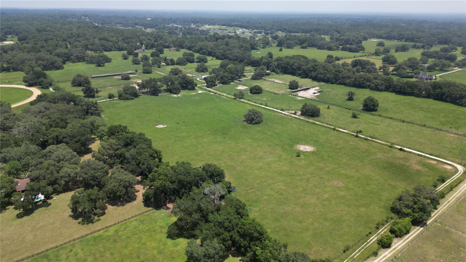 Under contract-accepting backup offers. Looking for some beautiful rolling land graced with Granddaddy Oaks to build your dream home or farm?
This 90.24 +/- acre consists of 3 parcels of land with beautiful Granddaddy Oaks, gently rolling land, and lush green pastures.
There is an existing 10-stall feeding barn, two covered buildings, and a mobile home on the property.
The property is located close to the Florida Greenways and Trails for hours of trail riding, plus conveniently located close to the Florida Horse Park.