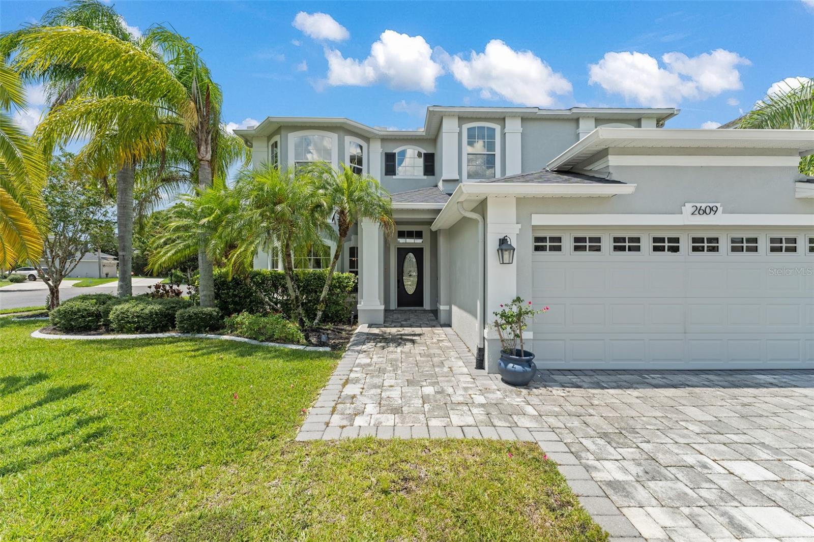 **This house comes with a REDUCED RATE through the seller's preferred lender. This is a lender-paid rate buydown that reduces the buyer's interest rate and monthly payment.** Welcome to 2609 Lakemoor Dr—a completely updated modern farmhouse-style pool home on an oversized corner lot with peaceful conservation views in the guard-gated Stoneybrook community. Every inch of this 4 bedroom, 3 bath home has been meticulously updated, including a new roof (2021), exterior paint (2022), new driveway pavers (2022), and beautifully done landscaping.? Inside, over 3,100 square feet of open living space features luxury vinyl plank flooring, a show-stopping kitchen with high-end finishes and Wi-Fi-enabled GE Profile appliances, and a seamless flow into the bright, open family room. The smart layout offers a main-level bedroom and full bath, with the remaining bedrooms and a spacious bonus room upstairs. The luxurious primary suite includes a spa-style bathroom with a grand double rainfall shower, an oversized walk-in closet, and a private balcony with serene views of the conservation.? Tech-savvy features include a Google Nest thermostat, Wi-Fi-enabled irrigation and market lights, outdoor speakers, and a smart front door lock. Step outside to your private screened-in pool and spa, surrounded by lush greenery and backing to a conservation area—no rear neighbors!? Stoneybrook offers resort-style amenities: a junior Olympic pool, full fitness center, tennis courts, sports fields, walking trails, and more. Digital HD cable and high-speed internet are included, and the community is zoned for top-rated schools with easy access to UCF, major highways, and Orlando International Airport?. This is more than a home—it’s a move-in-ready lifestyle upgrade. Don’t miss your chance to make it yours.