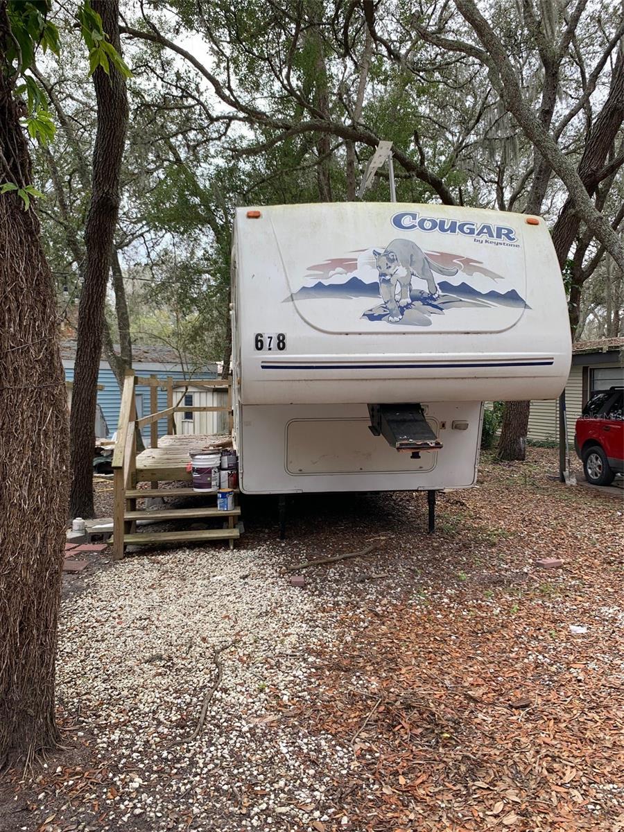 RV 5th wheel camper in a gated RV park for rent. One bedroom and one bathroom with utility shed. Located near West Orange trail and close to bus route, shopping, hospital, 30 minutes from Disney. Rent includes water, sewer, garbage pick-up, gated community with virtual guard, swimming pool, basketball, shuffleboard, mini-golf and much more.