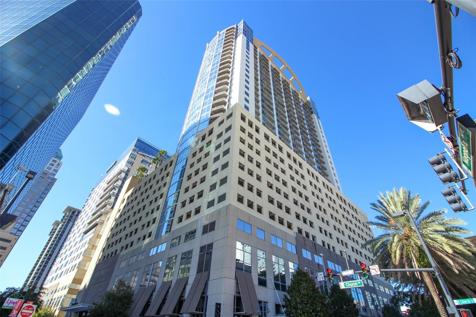 Welcome to this stunning 11th-floor 2 bed, 2 bath condo with unbeatable views in the heart of downtown Orlando. This modern, open-concept home features granite countertops, stainless steel appliances, a brand-new dishwasher and disposal, no carpets, and sleek finishes throughout. Enjoy your oversized private balcony, spacious bedrooms, in-unit laundry, ample storage, and two reserved parking spaces in prime location. Floor-to-ceiling tinted, hurricane-impact windows fill the space with natural light while keeping it cool year-round and maintaining your privacy. Walk to Lake Eola, the Kia Center, the Dr. Phillips Center, Publix, the farmers market, a plethora of restaurants and cafes, vibrant nightlife entertainment and more. Enjoy top-tier security with 24-hour security and concierge, biometric entry, and floor-specific fob access. The 10th-floor amenity level makes access quick and easy—no long elevator waits or crowded traffic and includes a rooftop pool and sundeck, a state-of-the-art fitness center, resident lounge available for rental and frequent events. HOA includes cable, high-speed internet, pest control, and more. Schedule your private showing today!