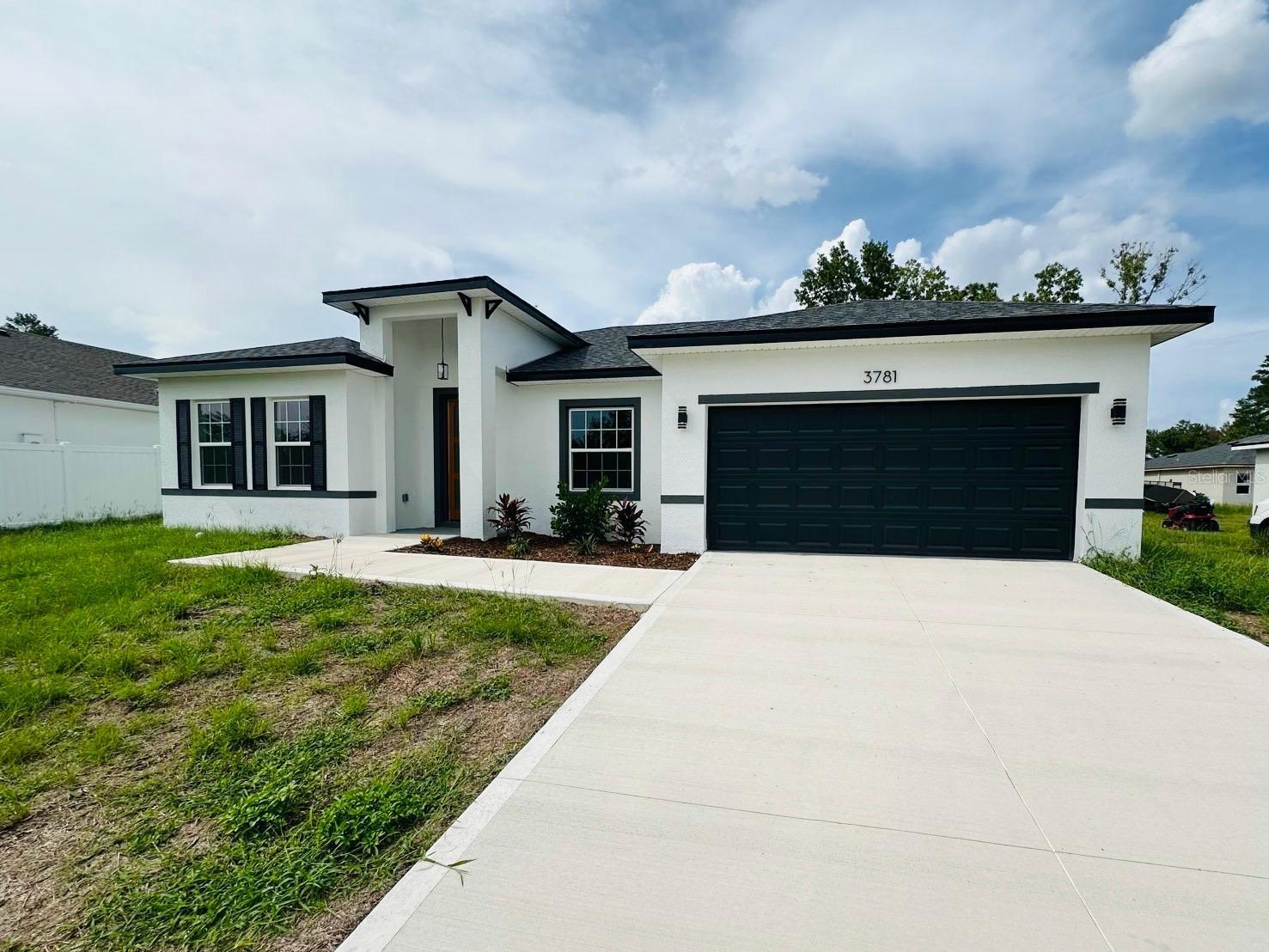 Discover your dream home or a great investment opportunity in a prime Ocala location! This modern, brand-new build features 4 spacious bedrooms and 2 luxurious bathrooms. Entertain with ease in the open-concept living area, flowing seamlessly into an amazing kitchen complete with ample cabinet space and stainless-steel appliances (range, refrigerator, disposal, dishwasher, microwave). The private primary suite is a true retreat, boasting a walk-in closet and an ensuite bathroom with dual vanities and a walk-in shower. Enjoy the durability and easy maintenance of vinyl flooring throughout. Don't miss out—schedule your showing today!